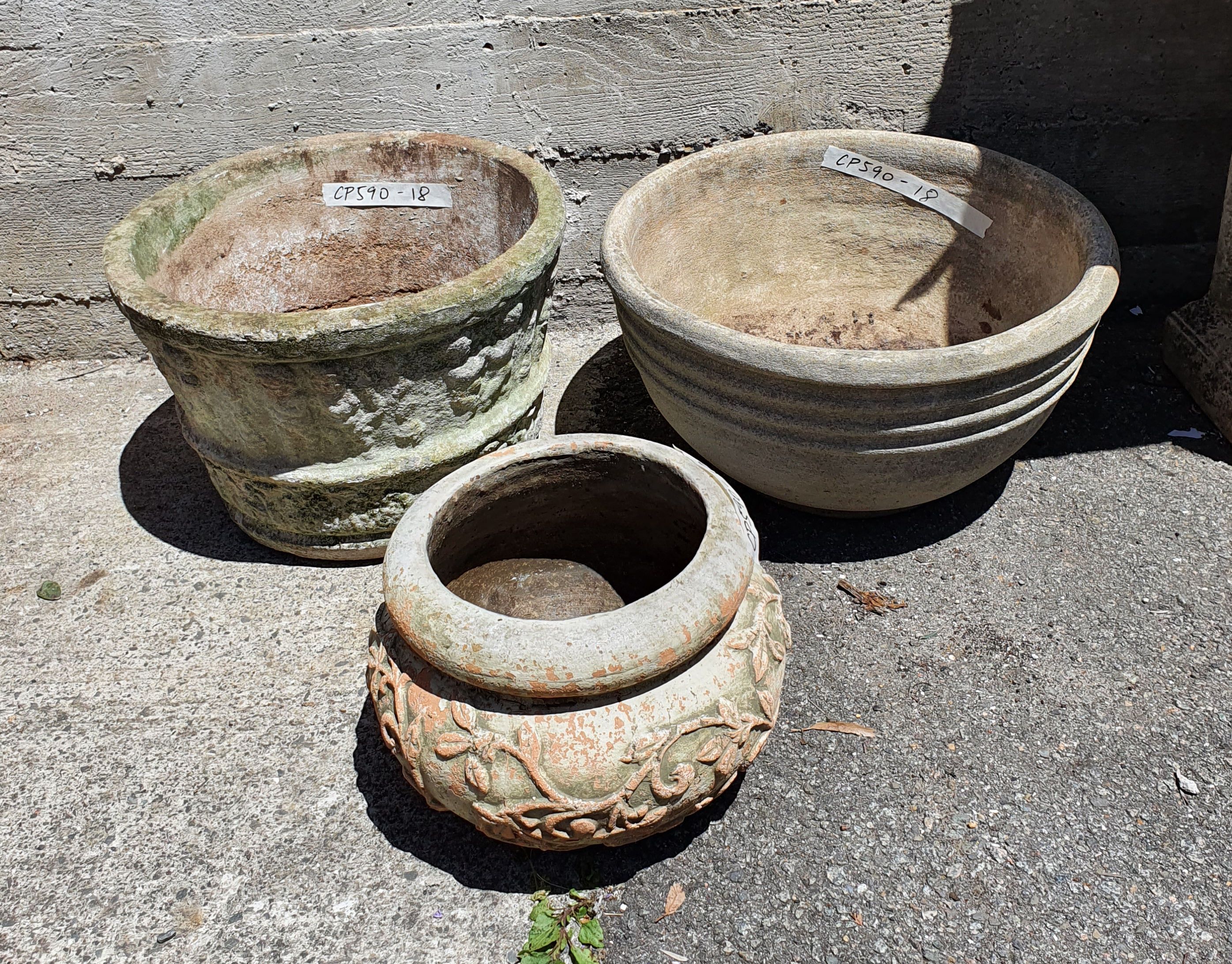 1104 · A GROUP OF CONCRETE POTS