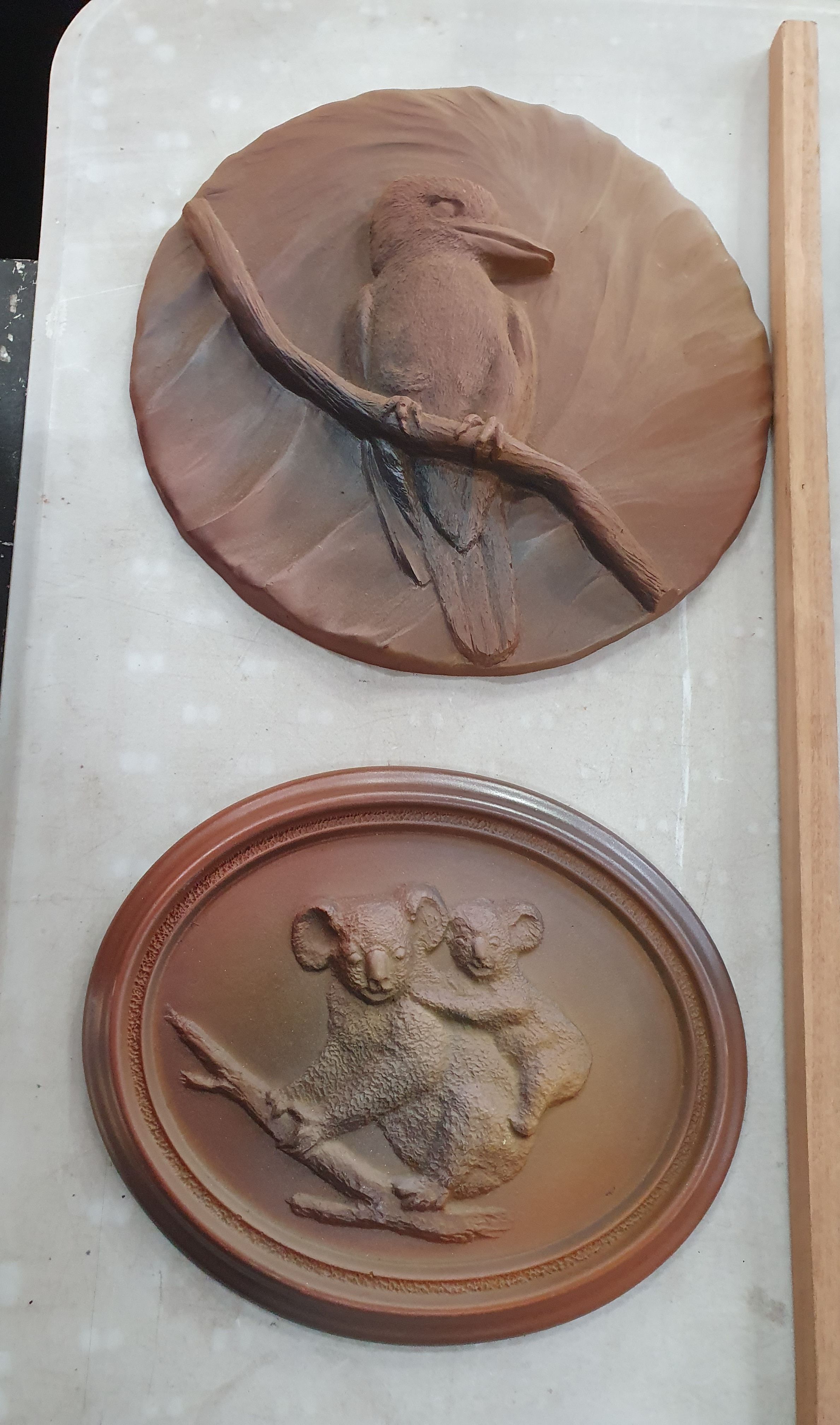 203 · TWO COMPOSITE RELIEF WALL PLAQUES
