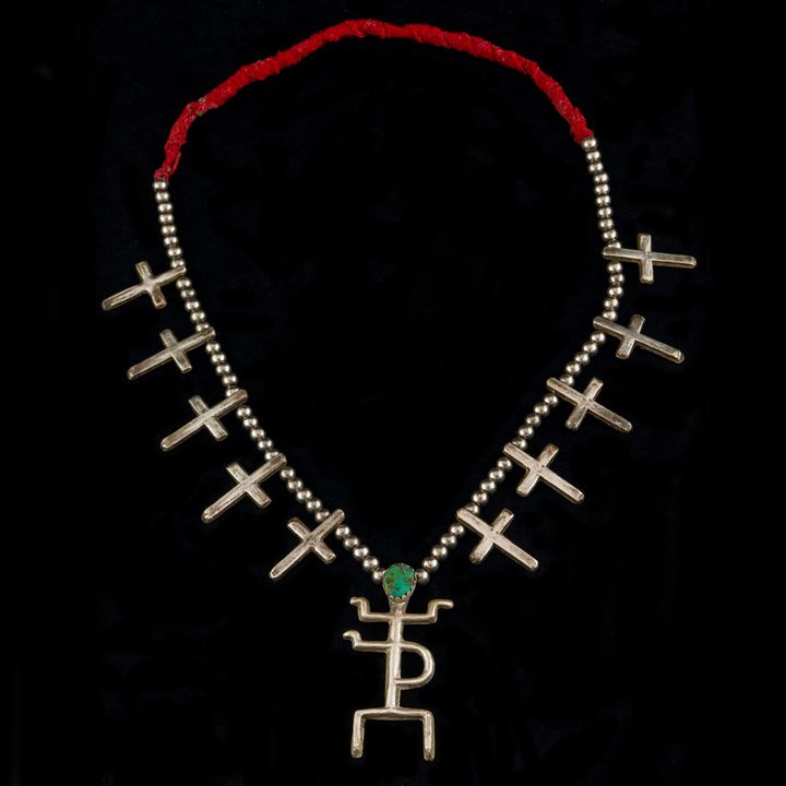 A Navajo coin silver necklace with 3 1/2" first man pendant, morning stars and trade beads