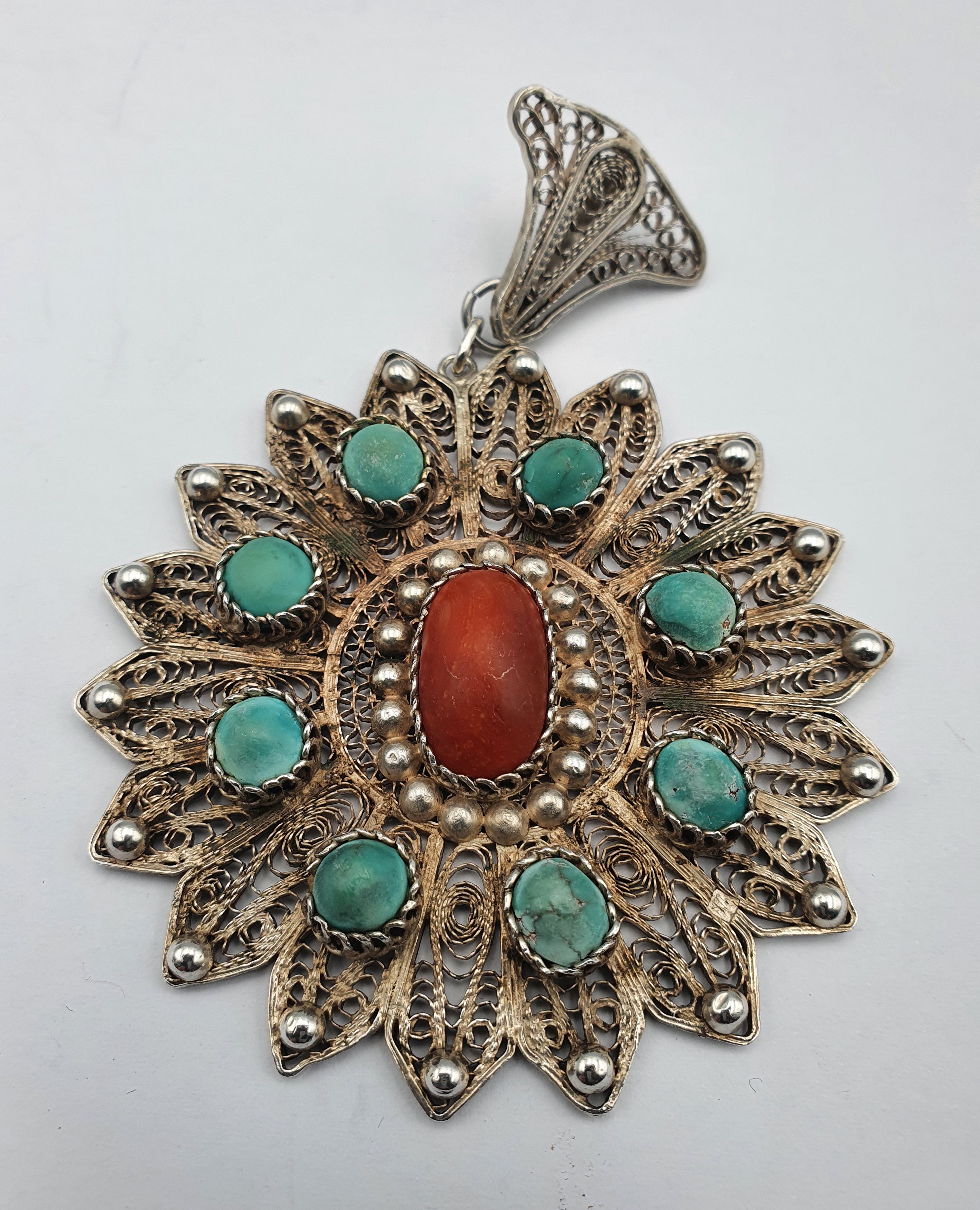 263 · A LARGE SILVER FILIGREE PENDANT WITH CORAL AND TURQUOISE INCLUSIONS