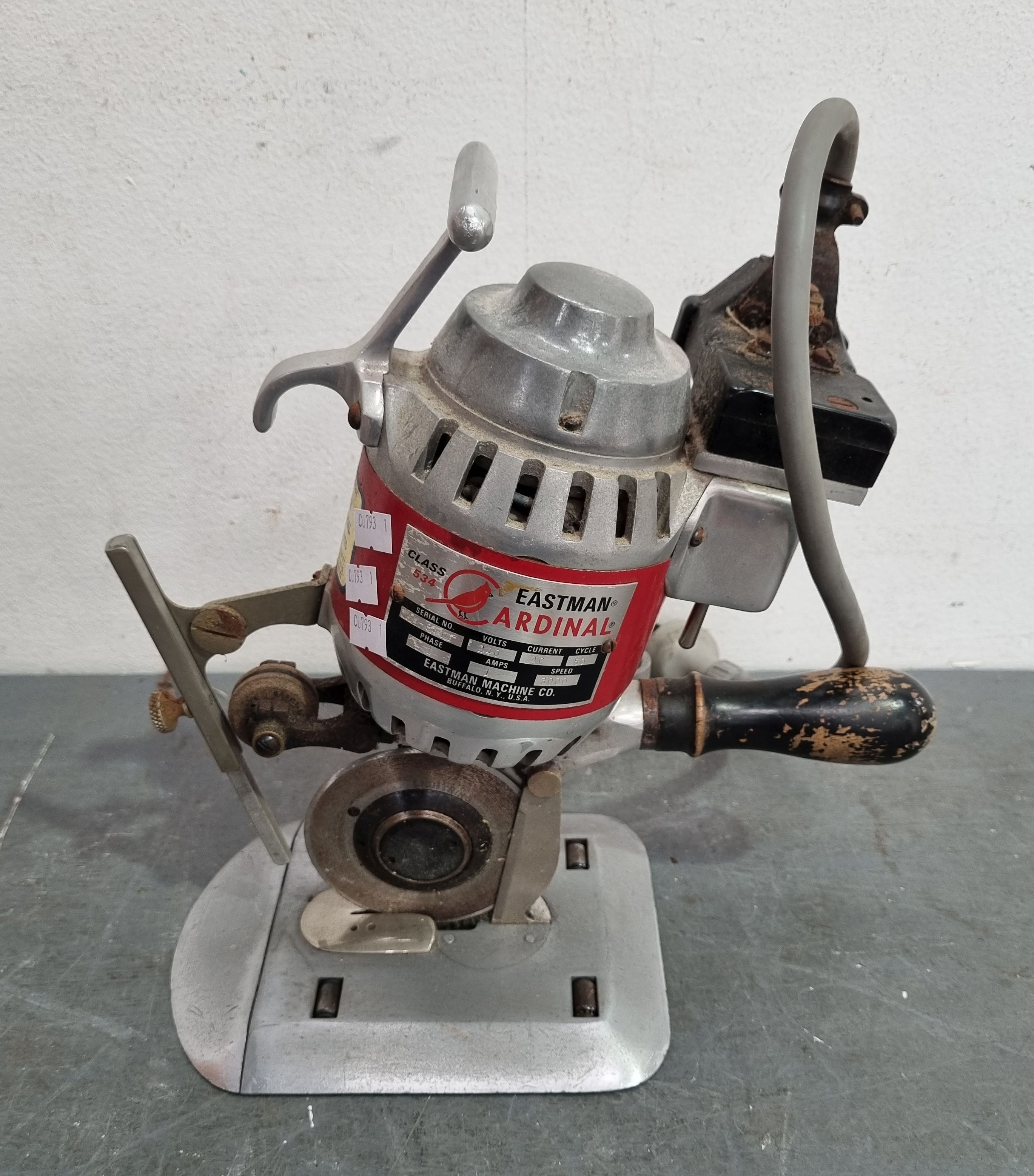 A VINTAGE EASTMAN CARDINAL INDUSTRIAL FABRIC CUTTER