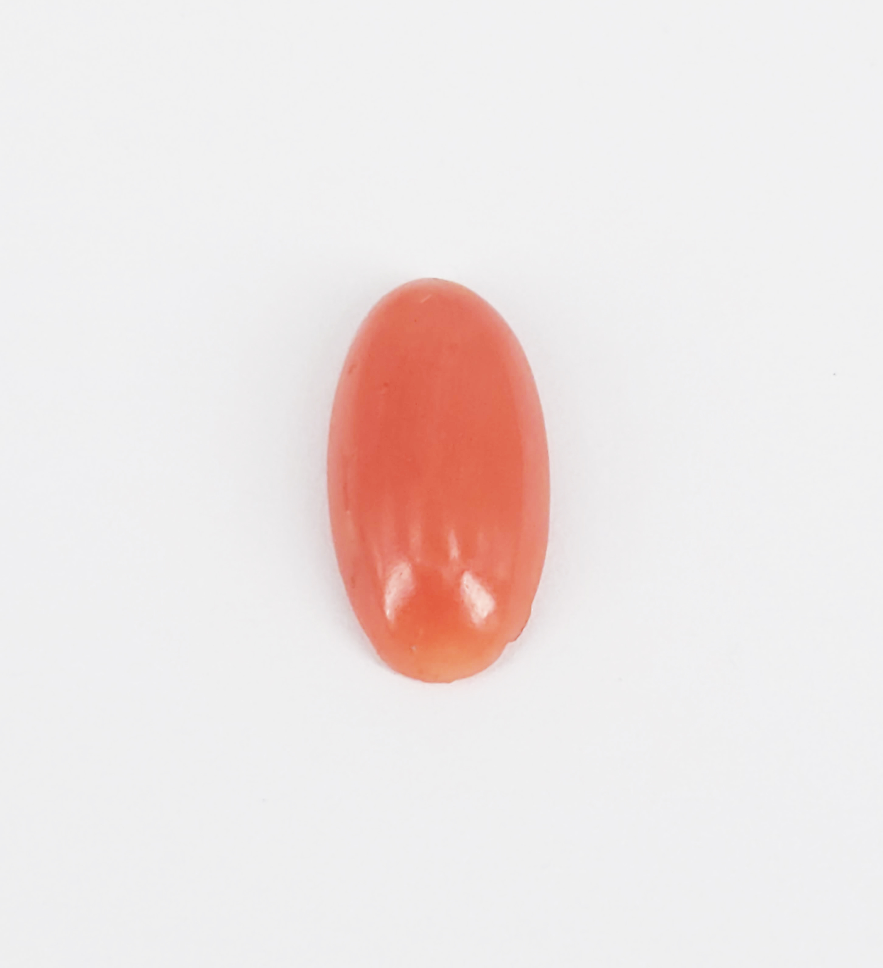 A RED CORAL CABOCHON