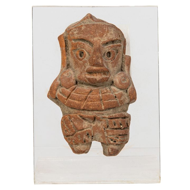 A Pre Columbian red clay figure mounted on a lucite stand