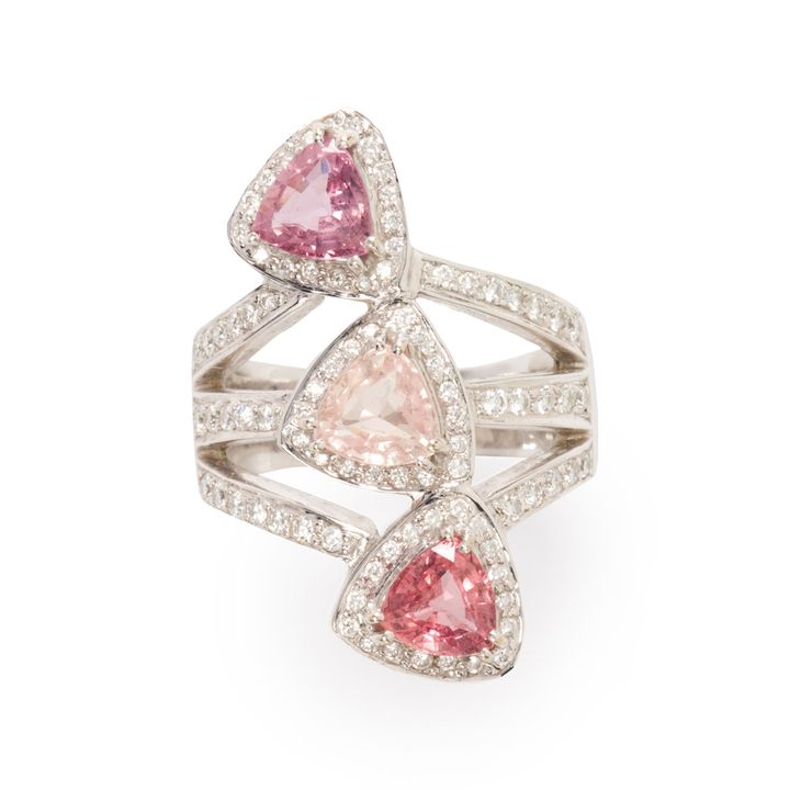 A multi-hued sapphire, diamond and eighteen karat white gold ring.