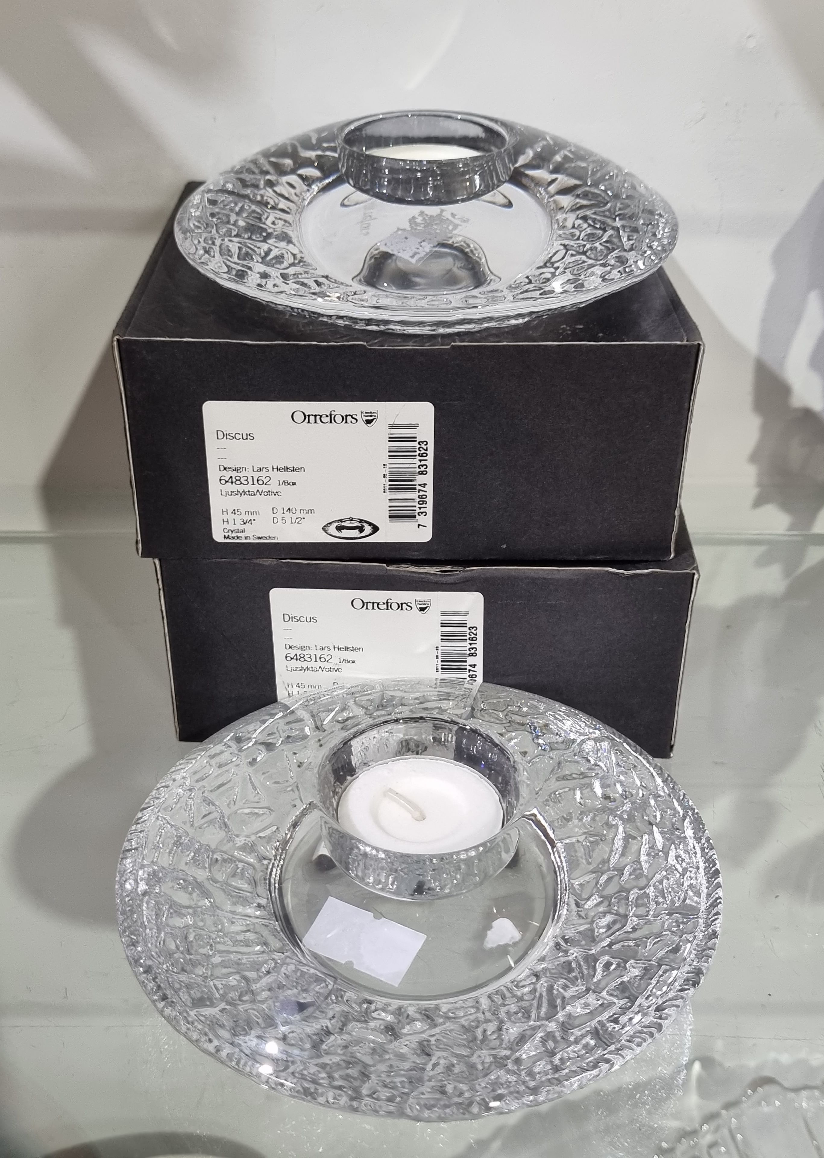 625 · A PAIR OF ORREFORS DISCUS GLASS TEALIGHT HOLDERS