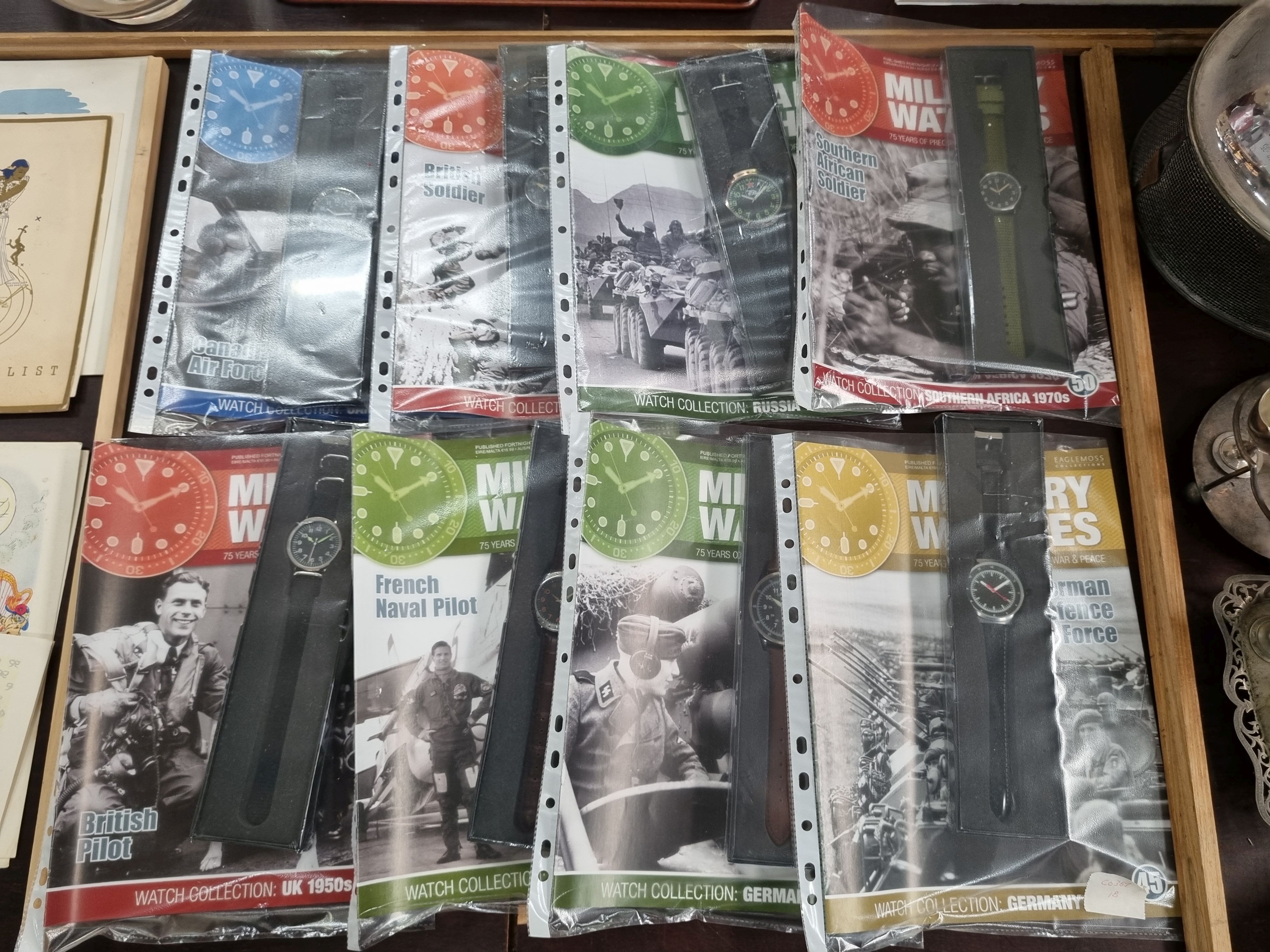 202 · EIGHT 'MILITARY WATCHES' MAGAZINES AND ASSOCIATED REPRODUCTION WATCHES