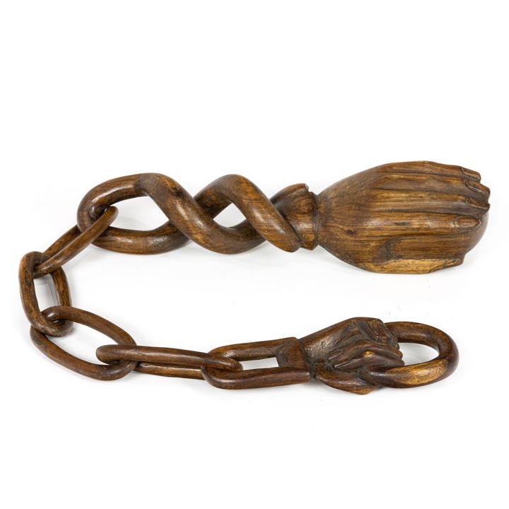 A Folk Art carved whimsy chain with two hands