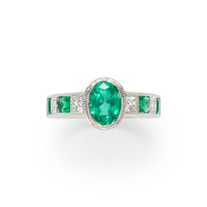 An emerald, diamond and fourteen karat white gold ring
