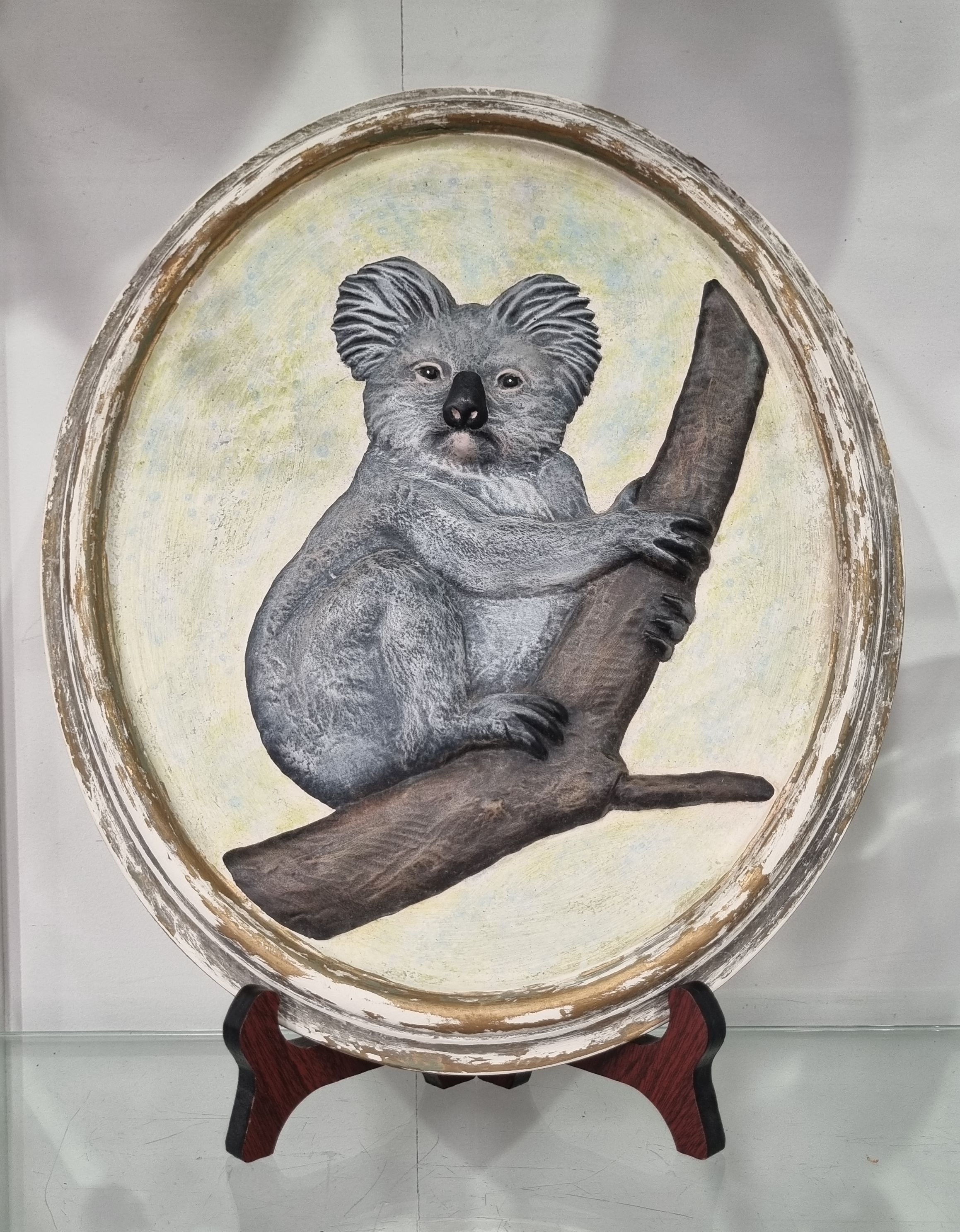 A PLASTER KOALA OVAL WALL PLAQUE