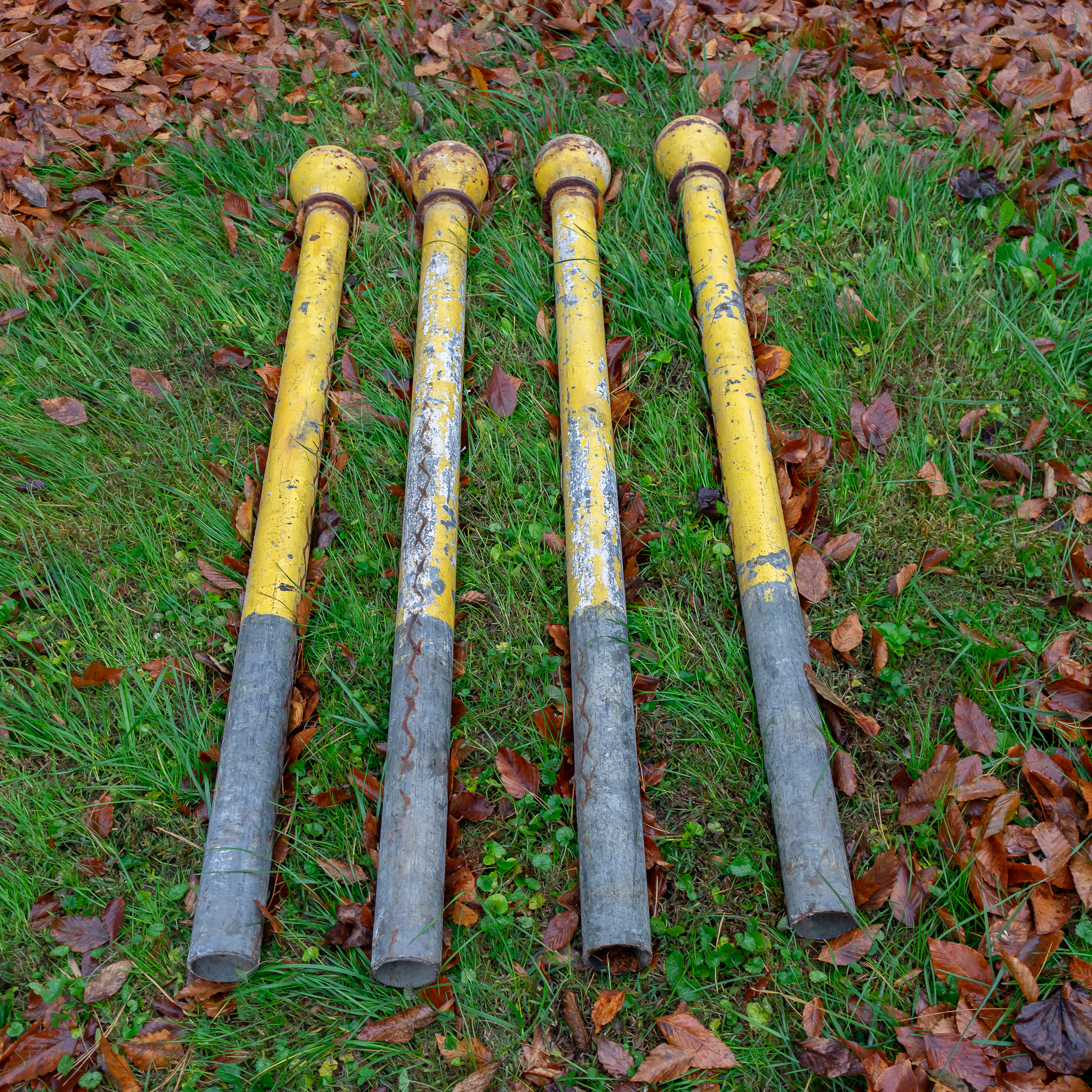 Antique Yellow Painted Fence Posts | Harritt Group, Inc