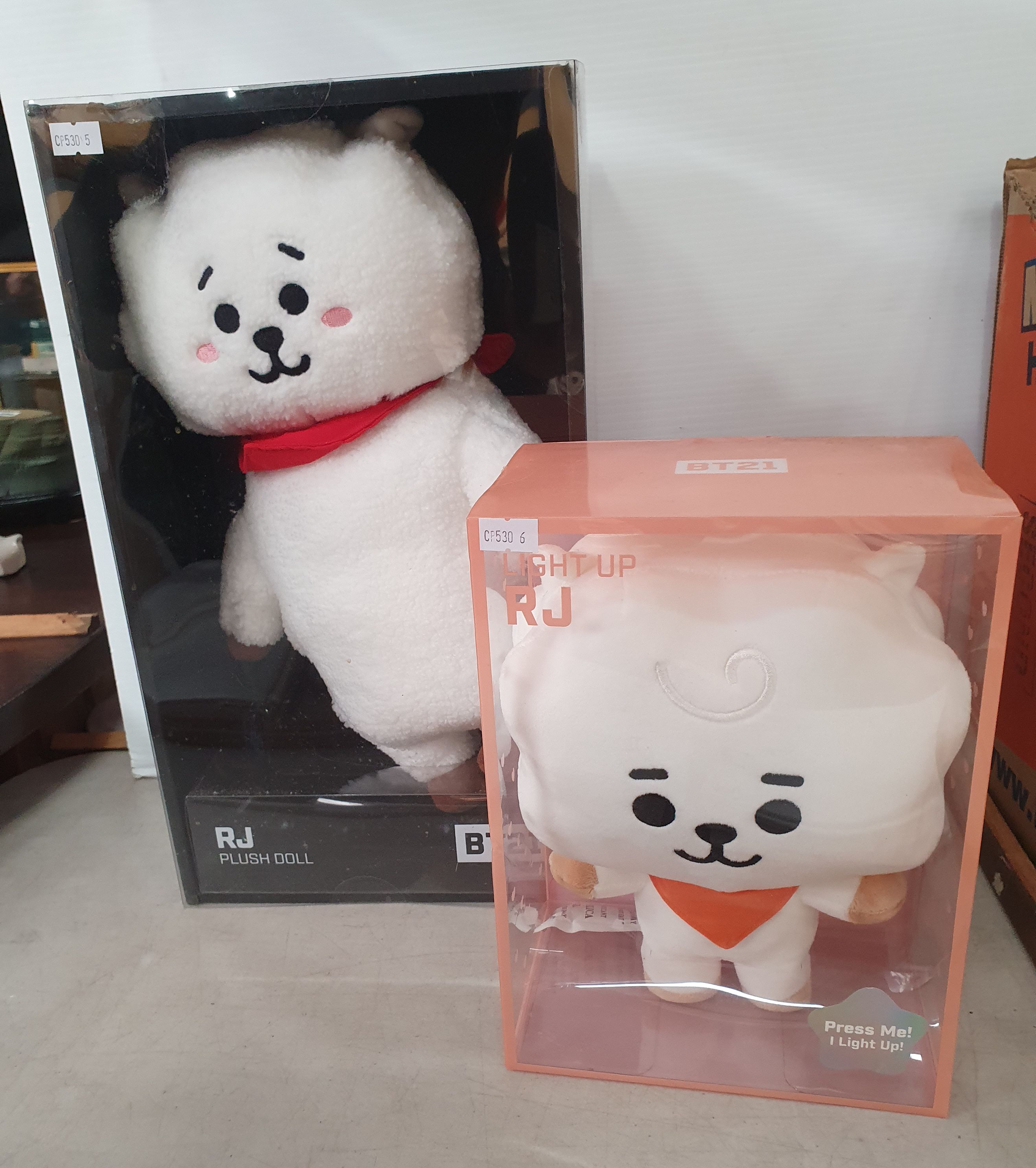 106 · AN 'R J' PLUSH DOLL AND LIGHT UP DOLL