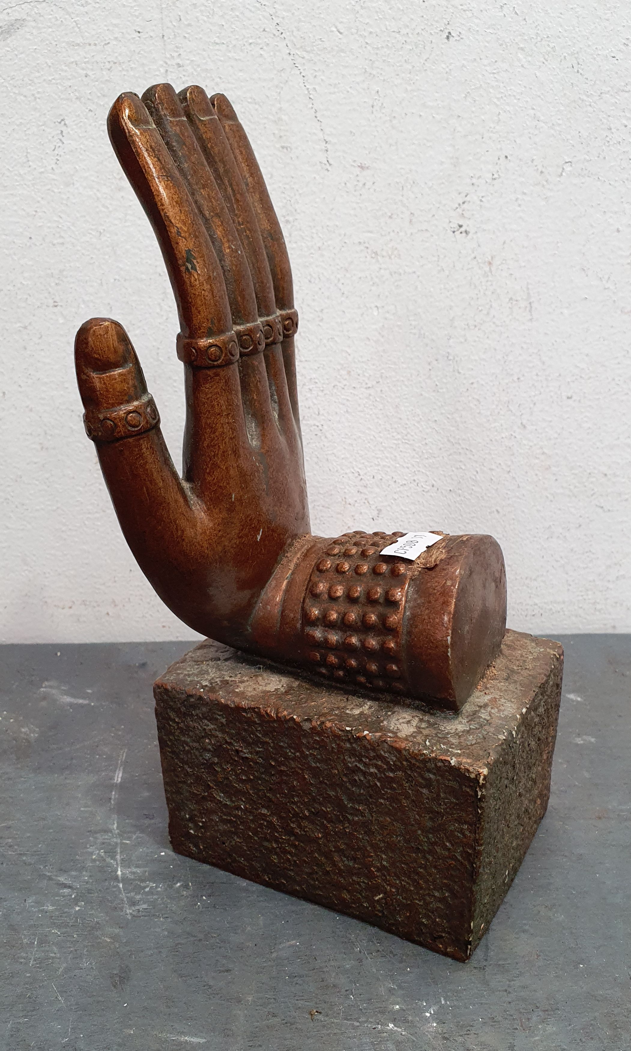 AN ORIENTAL RIGHT HAND STATUETTE