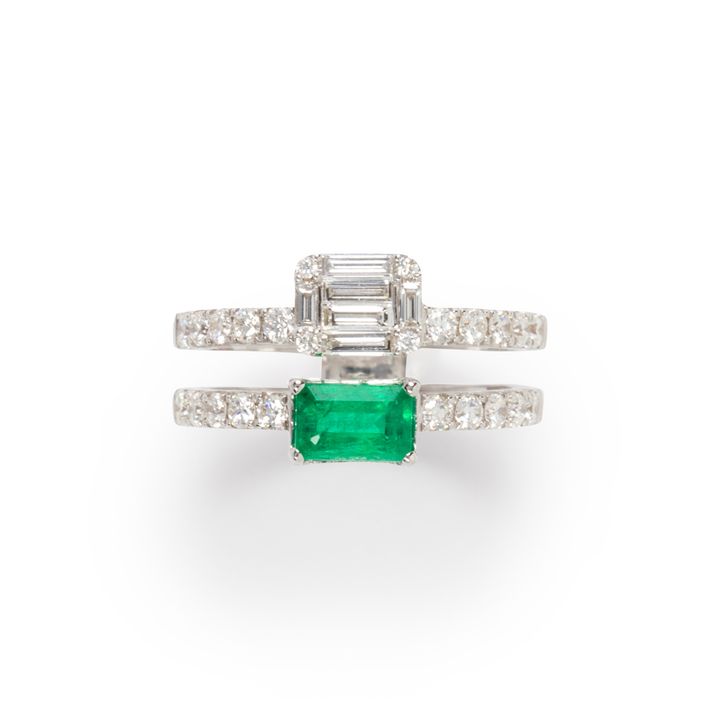 An emerald, diamond and eighteen karat white gold ring