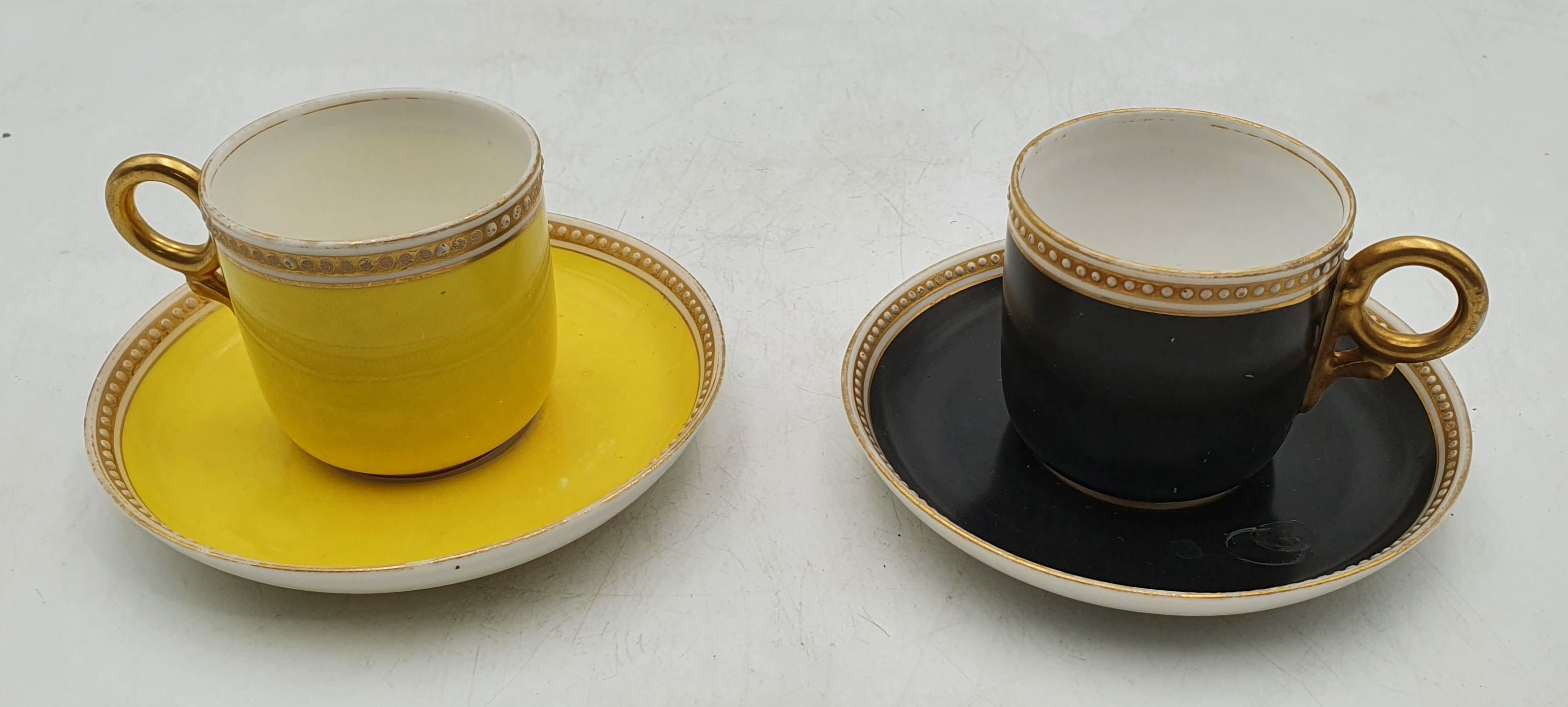 A PAIR OF ROYAL WORCESTER COFFEE CANS AND SAUCERS