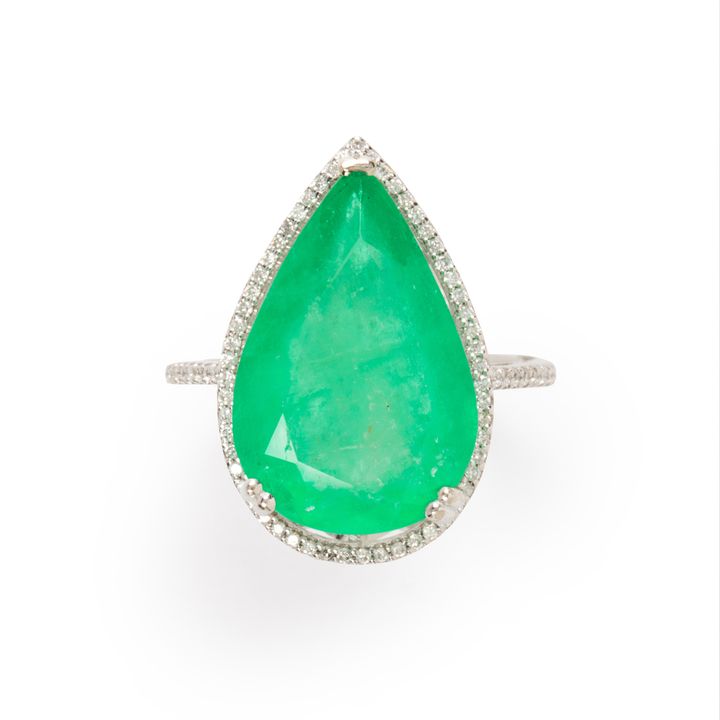 An emerald, diamond and fourteen karat white gold ring