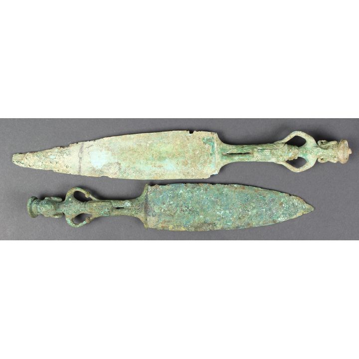 (lot of 2) Dongson bronze daggers, each of the handles of anthropomorphic form with large earrings and hands at the hips, largest: 11