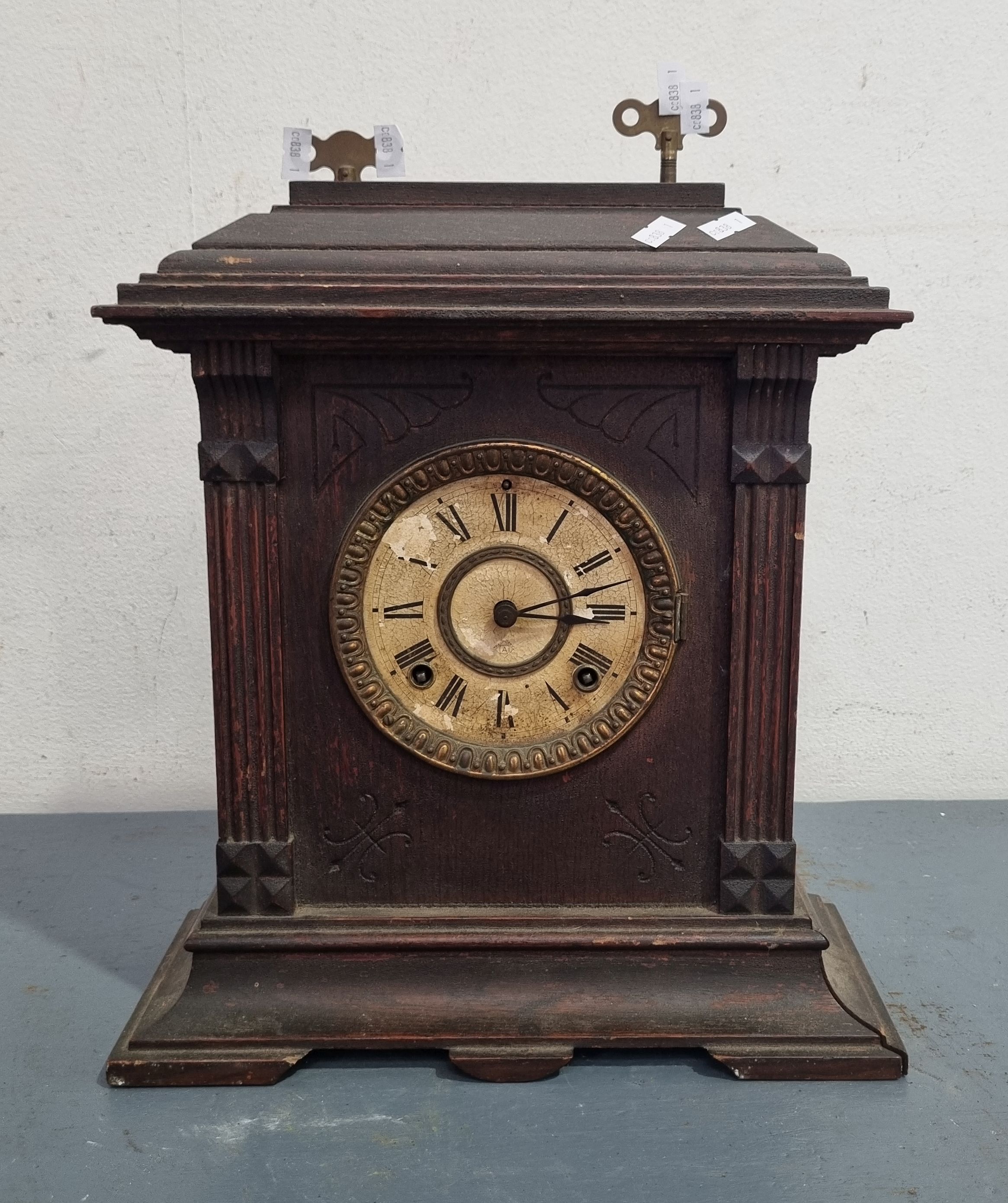 A WELL AGED MANTEL CLOCK