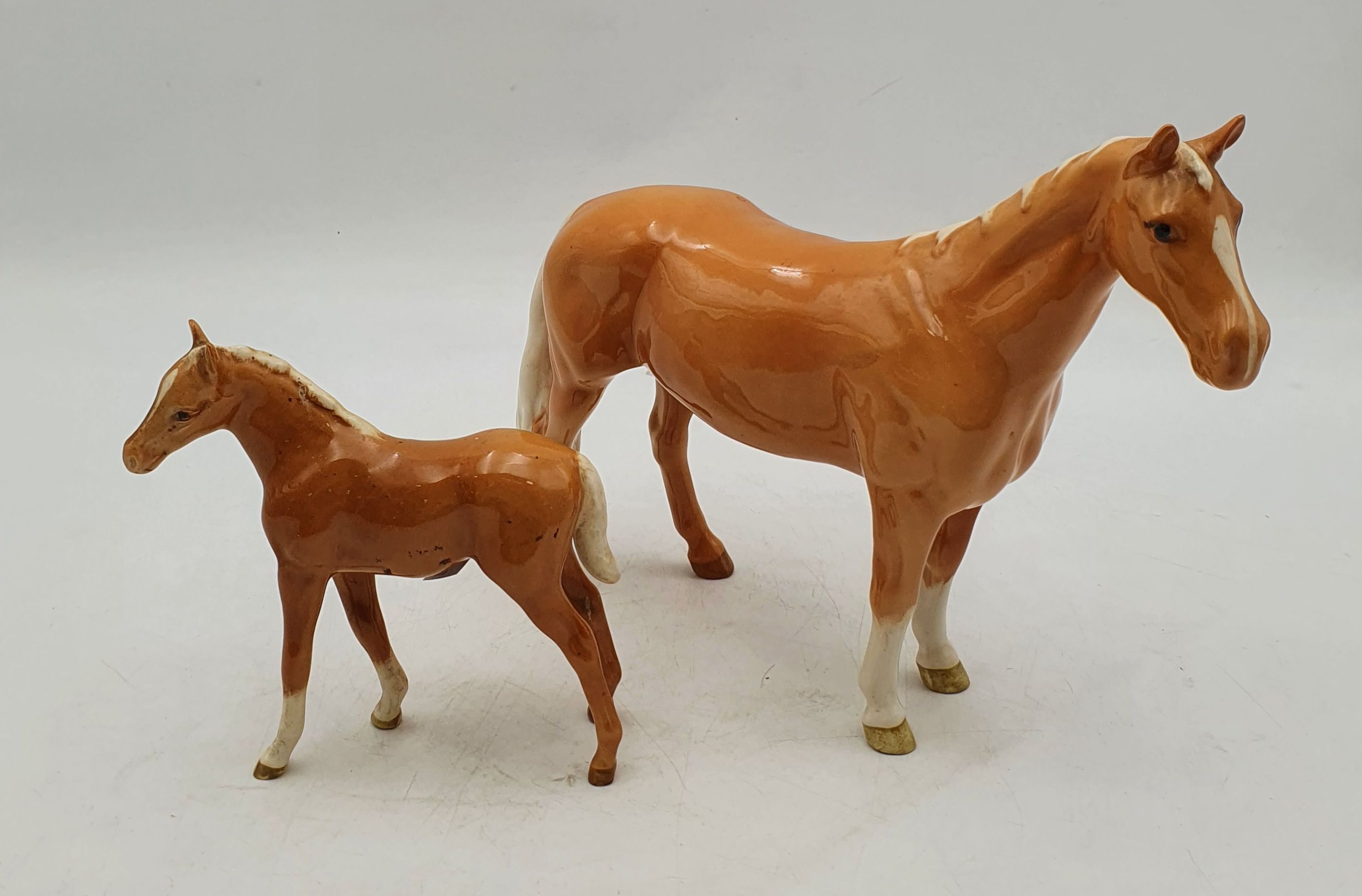A BESWICK PALOMINO MARE AND FOAL