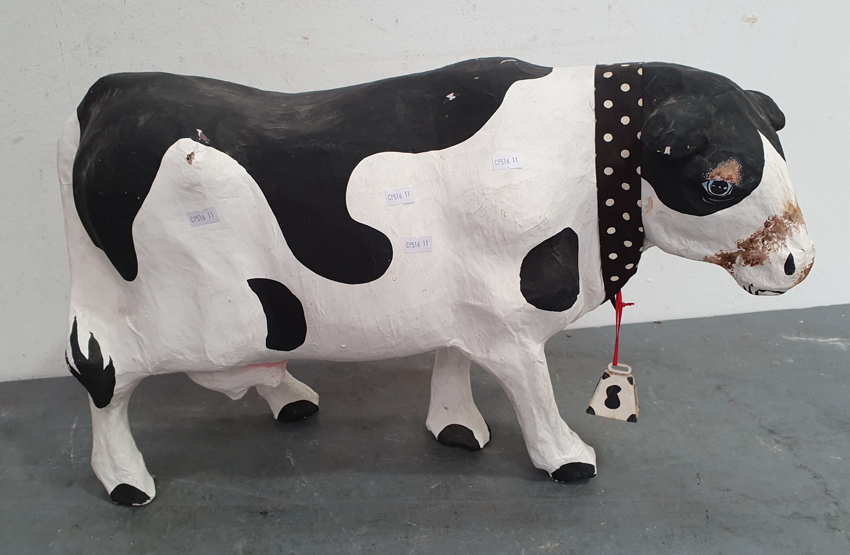 A Paper Mache Cow With Bell
