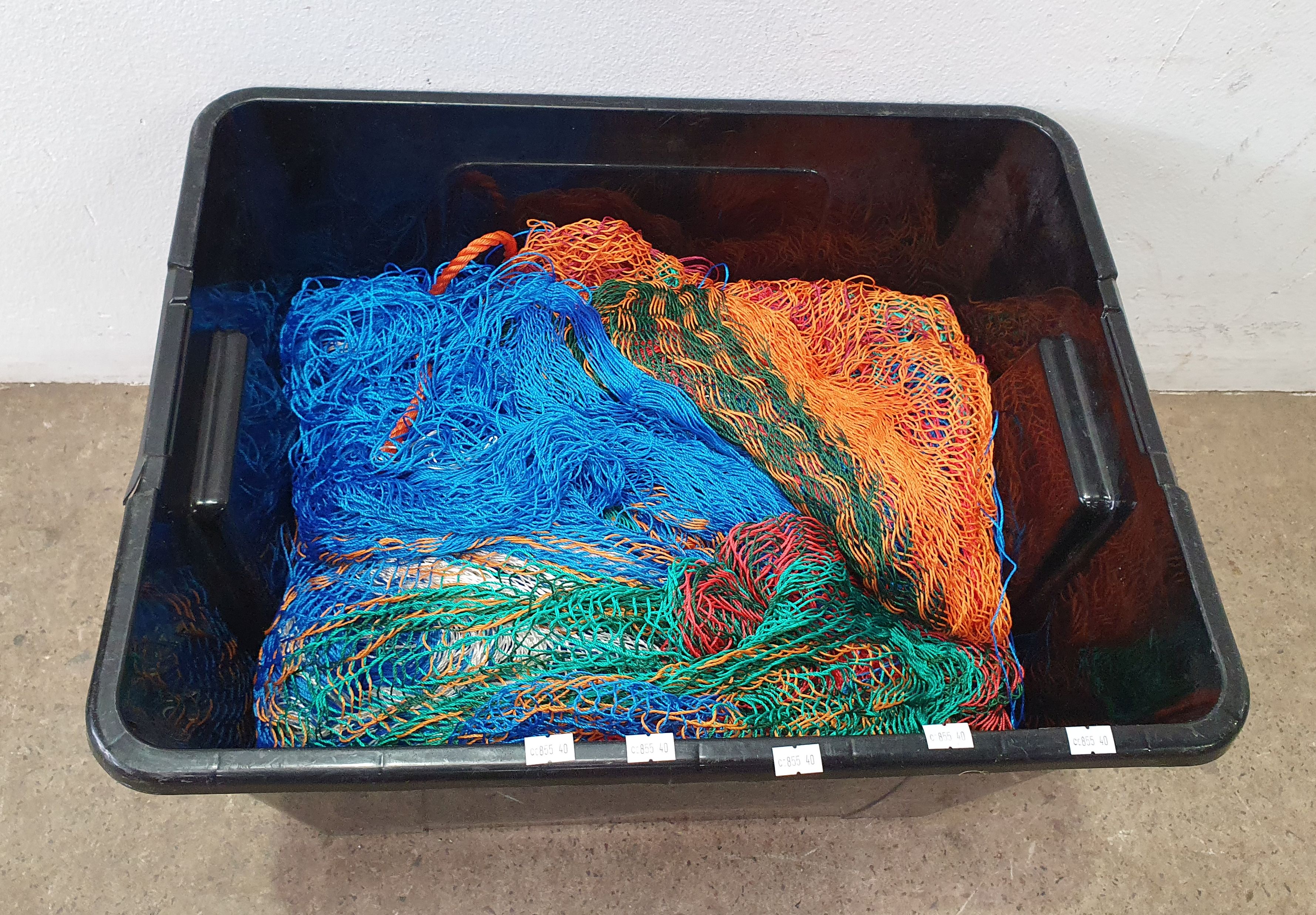 A BOX OF FISHING NETS