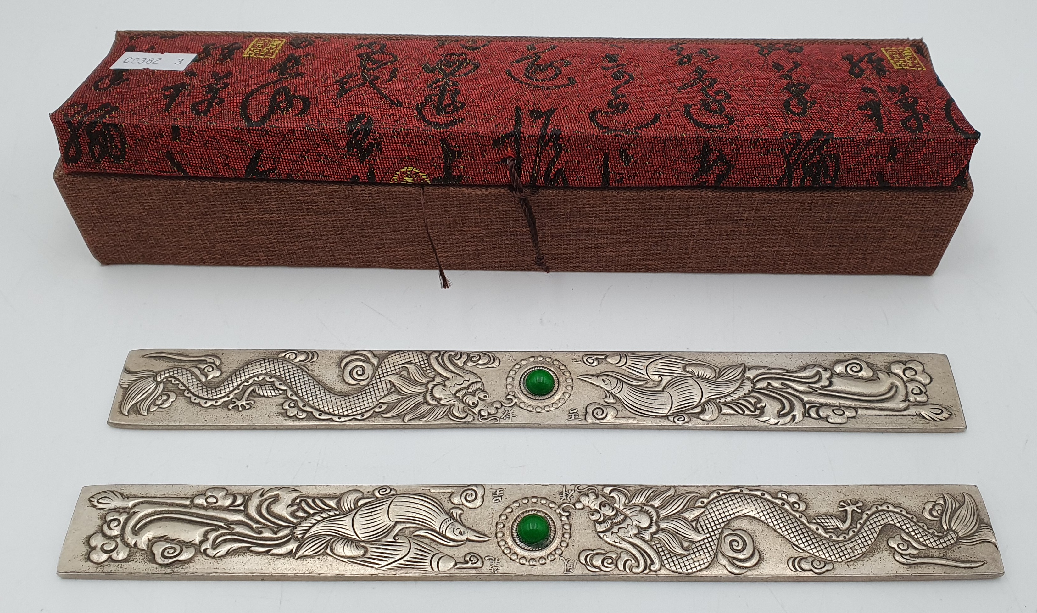 549 · A PAIR OF CHINESE WHITE METAL SCROLL WEIGHTS