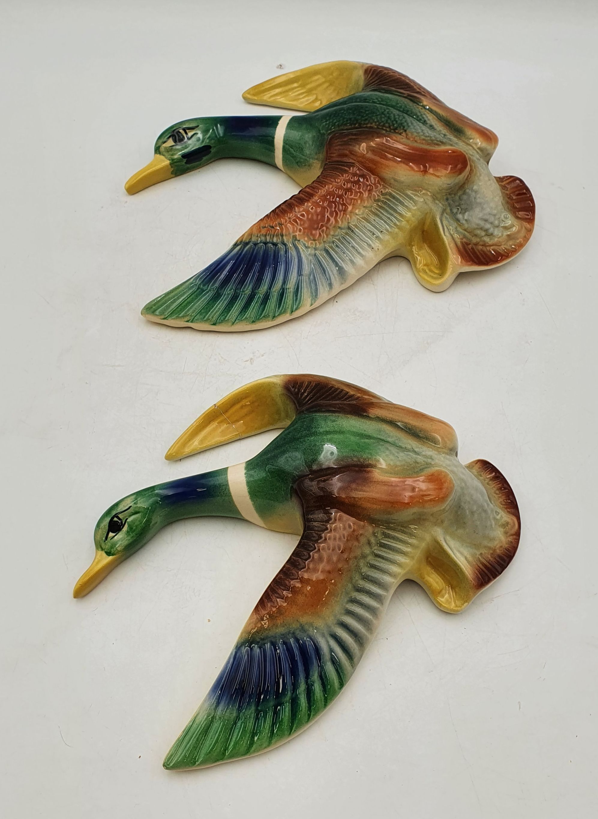 A Set Of Two Mcp Graduating Flying Duck Figures