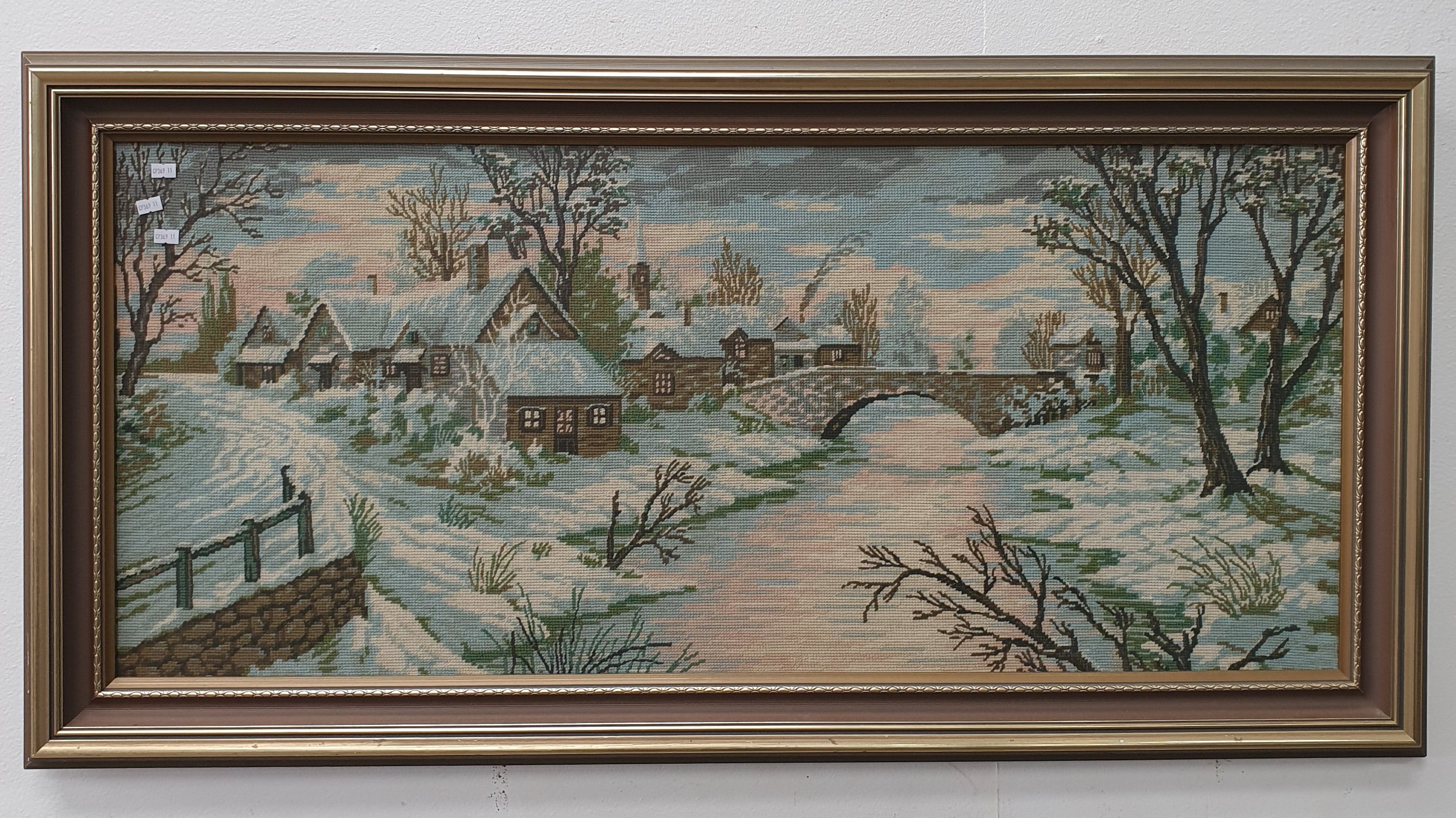 A FRAMED NEEDLEPOINT ARTWORK