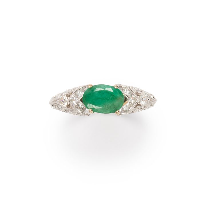 An emerald, diamond and eighteen karat white gold ring