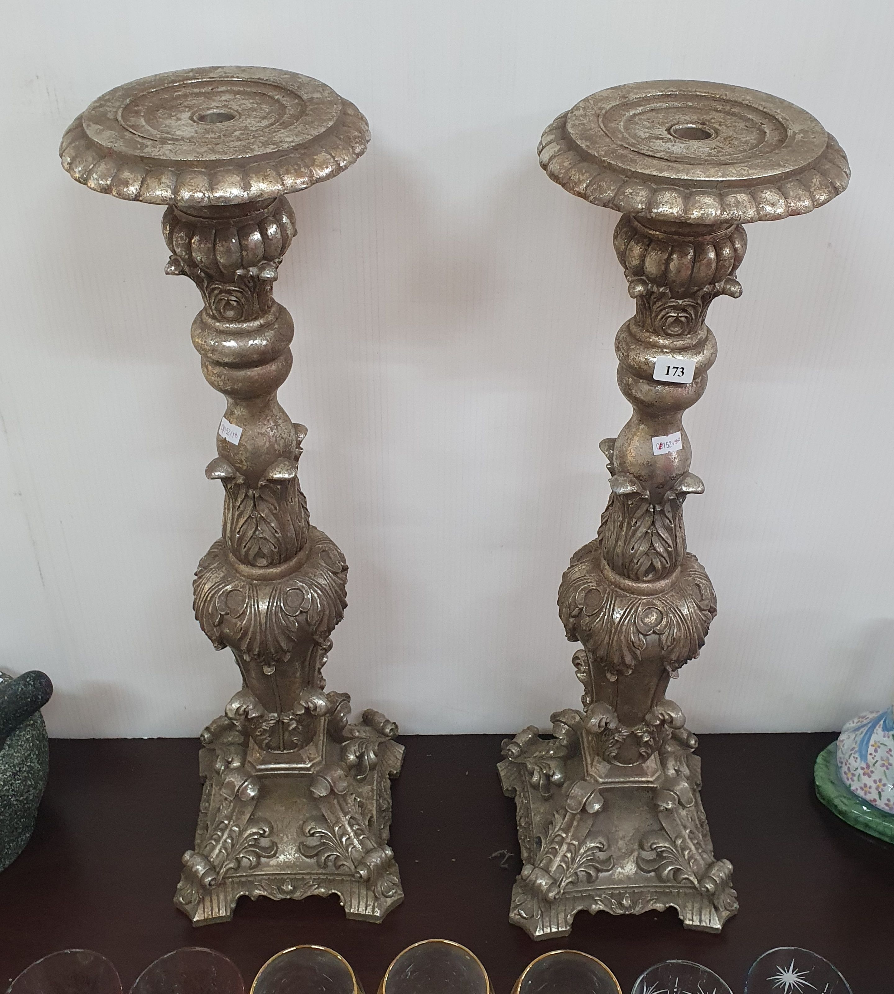 A PAIR OF TALL DECORATIVE COMPOSITE CANDLE STANDS