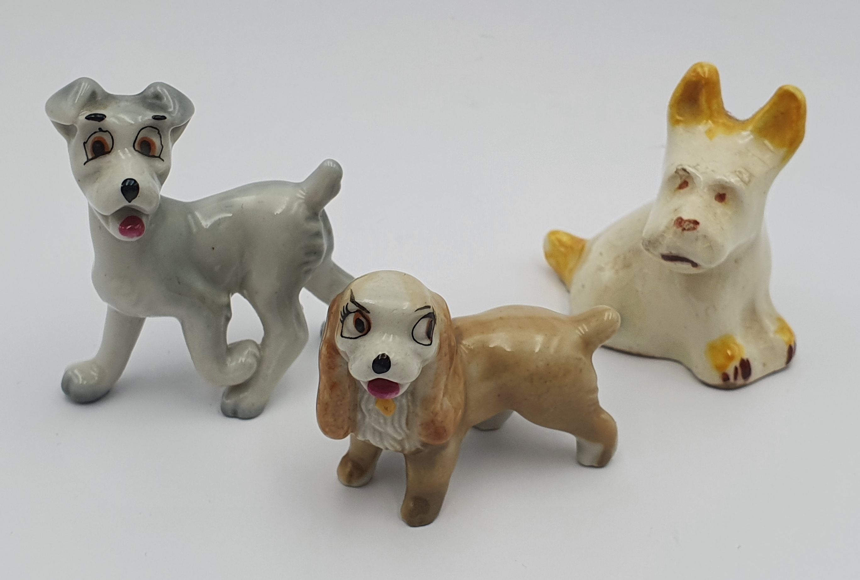 341 · THREE MINIATURE PORCELAIN DOGS