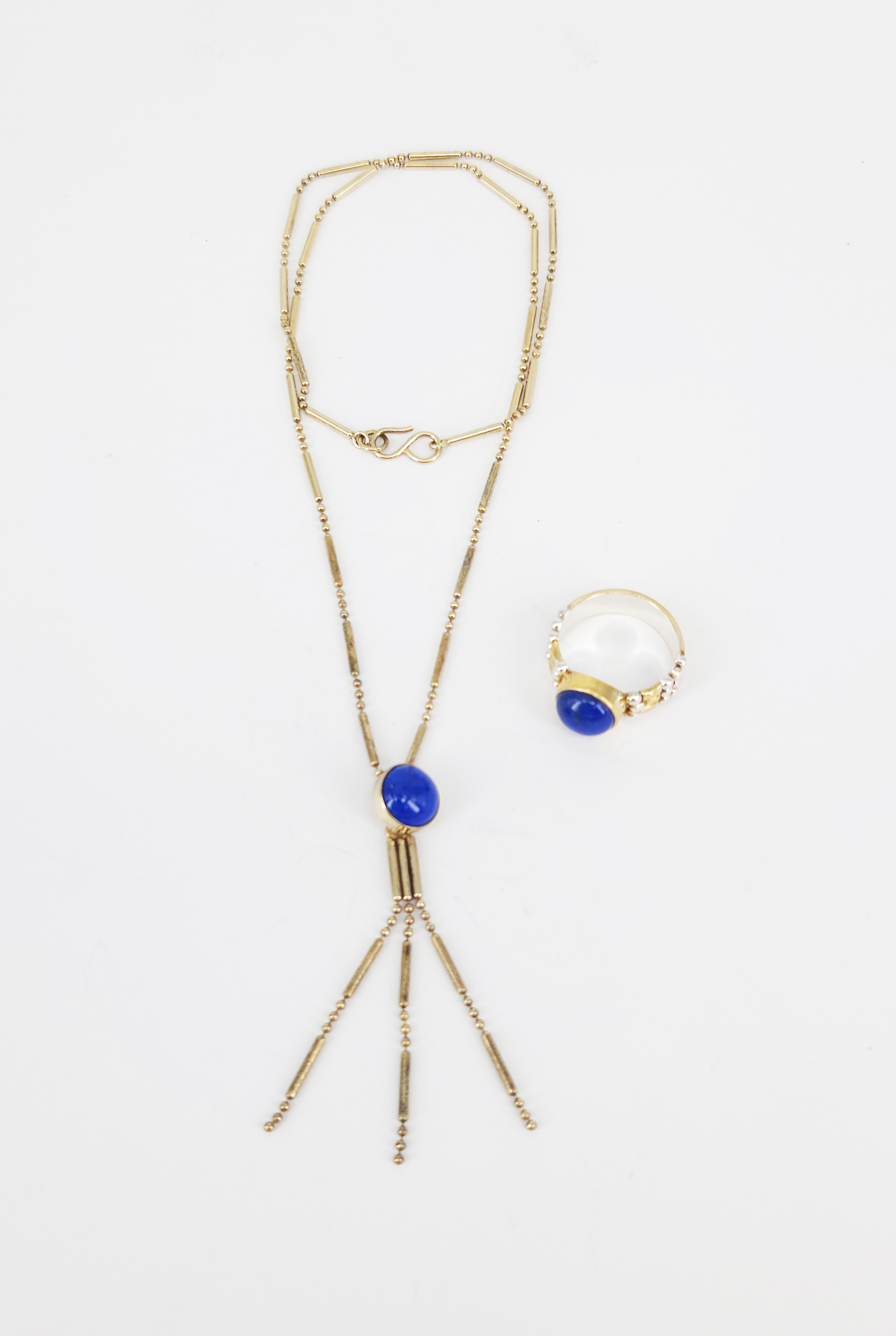 324 · A SILVER GILT AND LAPIS LAZULI NECKLACE AND RING SET
