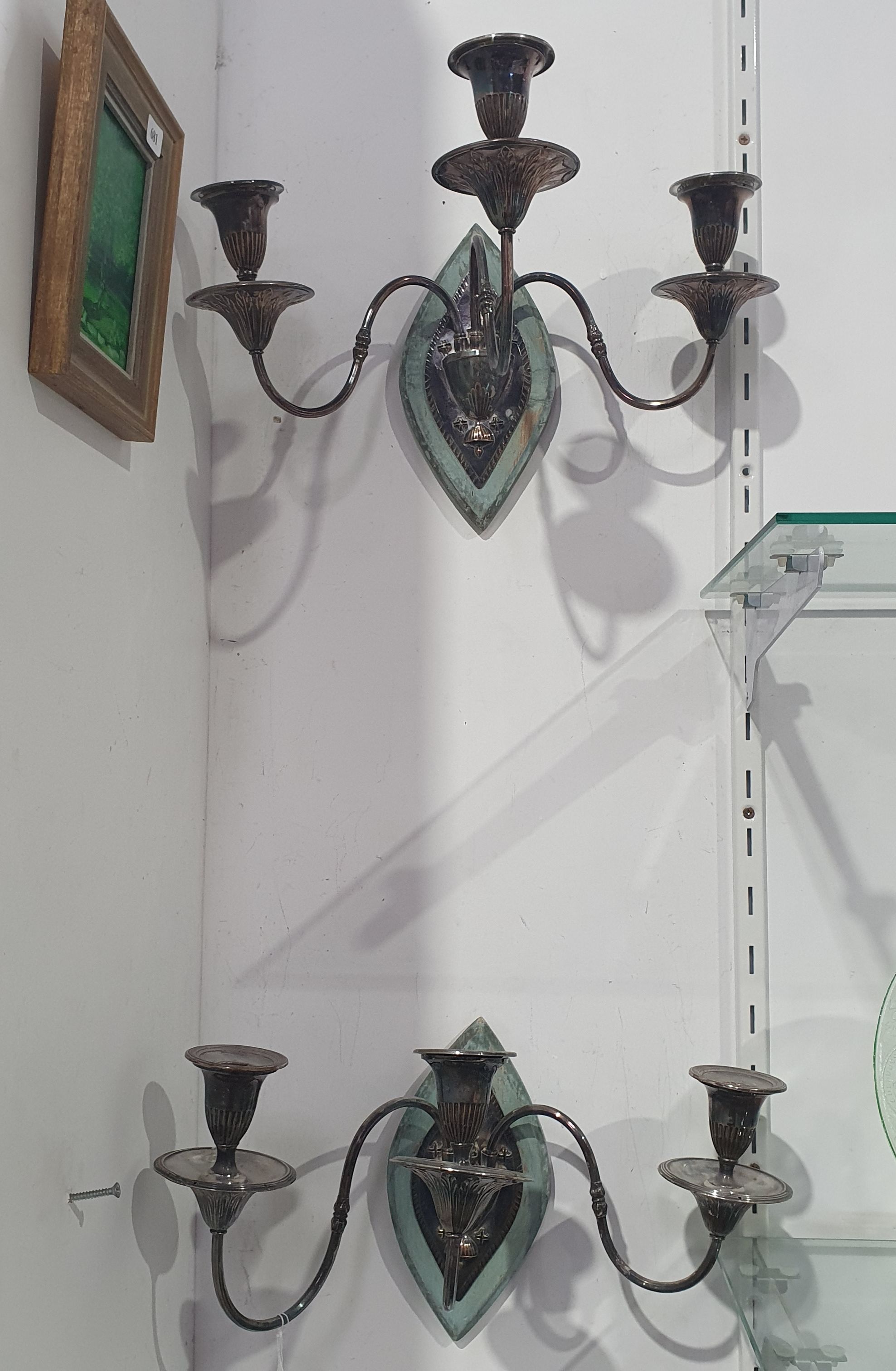 A PAIR OF SILVER ON COPPER THREE LIGHT WALL SCONCES