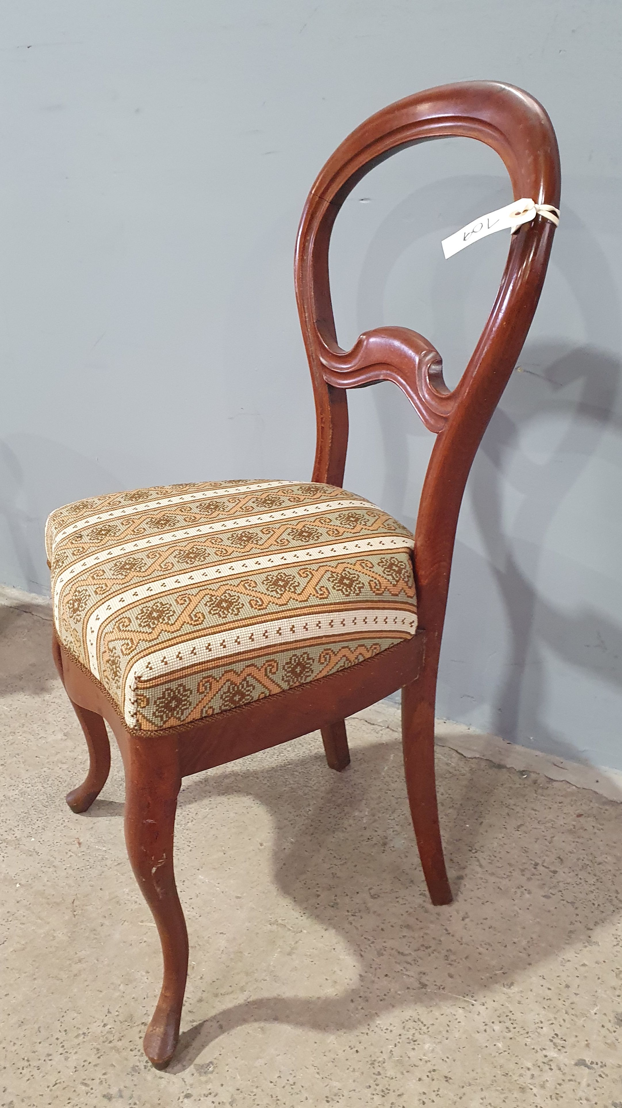 An Upholstered Balloon Back Chair