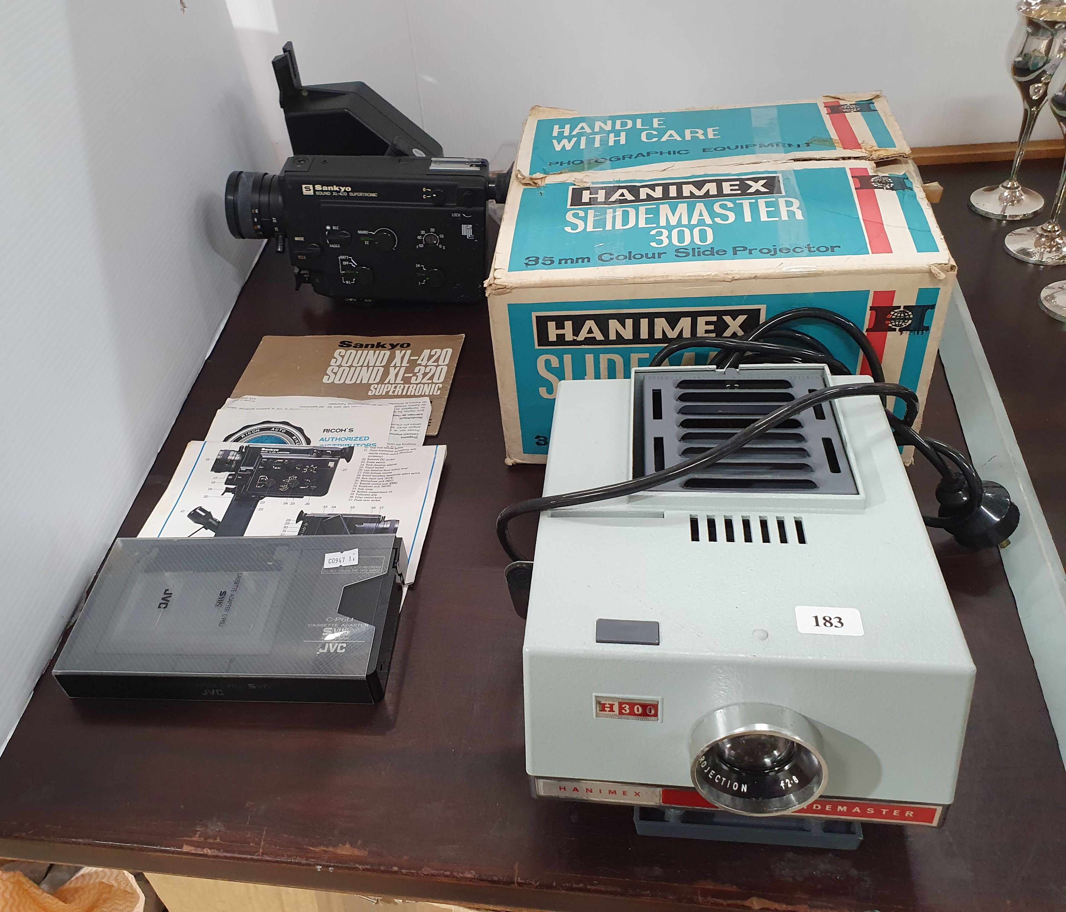 A Sankyo Video Camera And A Hanimex Slide Master Projector