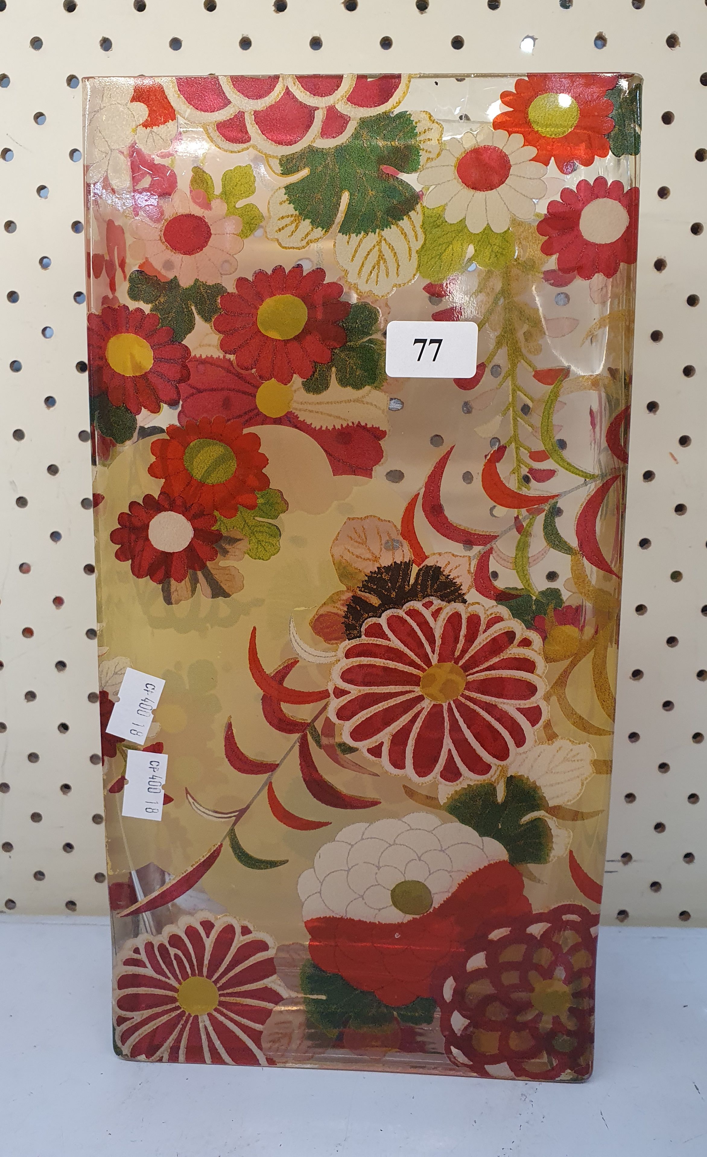 77 · A FLORAL MOTIF GLASS BRICK VASE