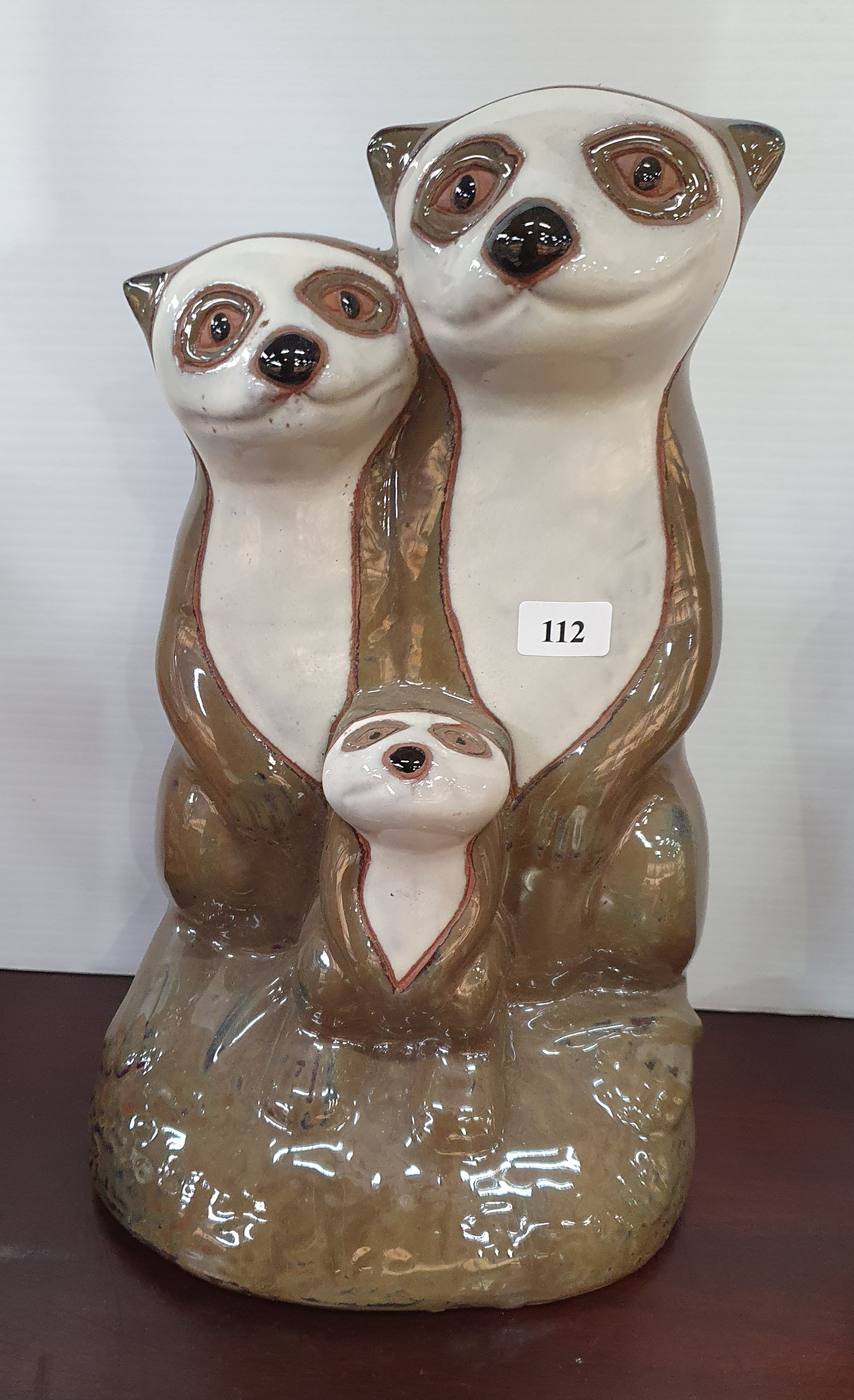 112 · A GLAZED POTTERY MEERKAT FIGURE GROUP