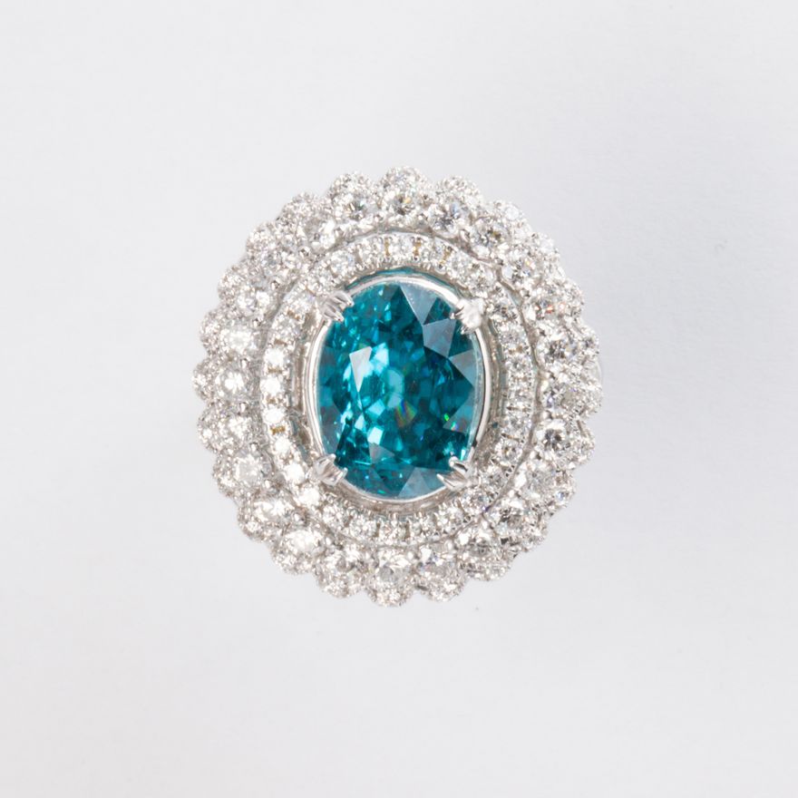 A blue zircon, diamond and fourteen karat gold ring