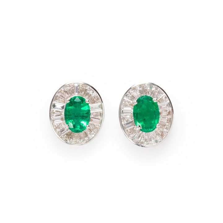 A pair of emerald, diamond and eighteen karat white gold earrings