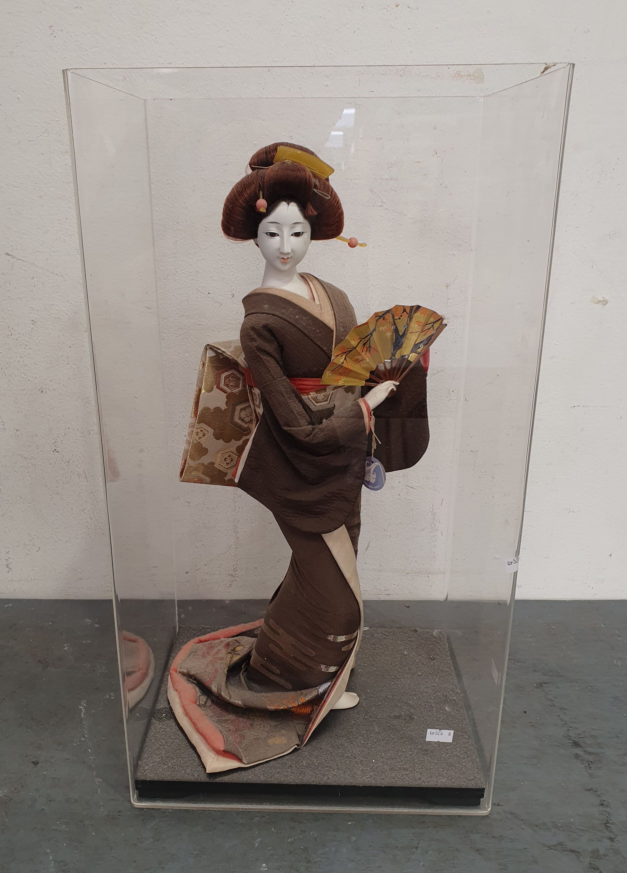 AN ASIAN FIGURE IN A PERSPEX BOX