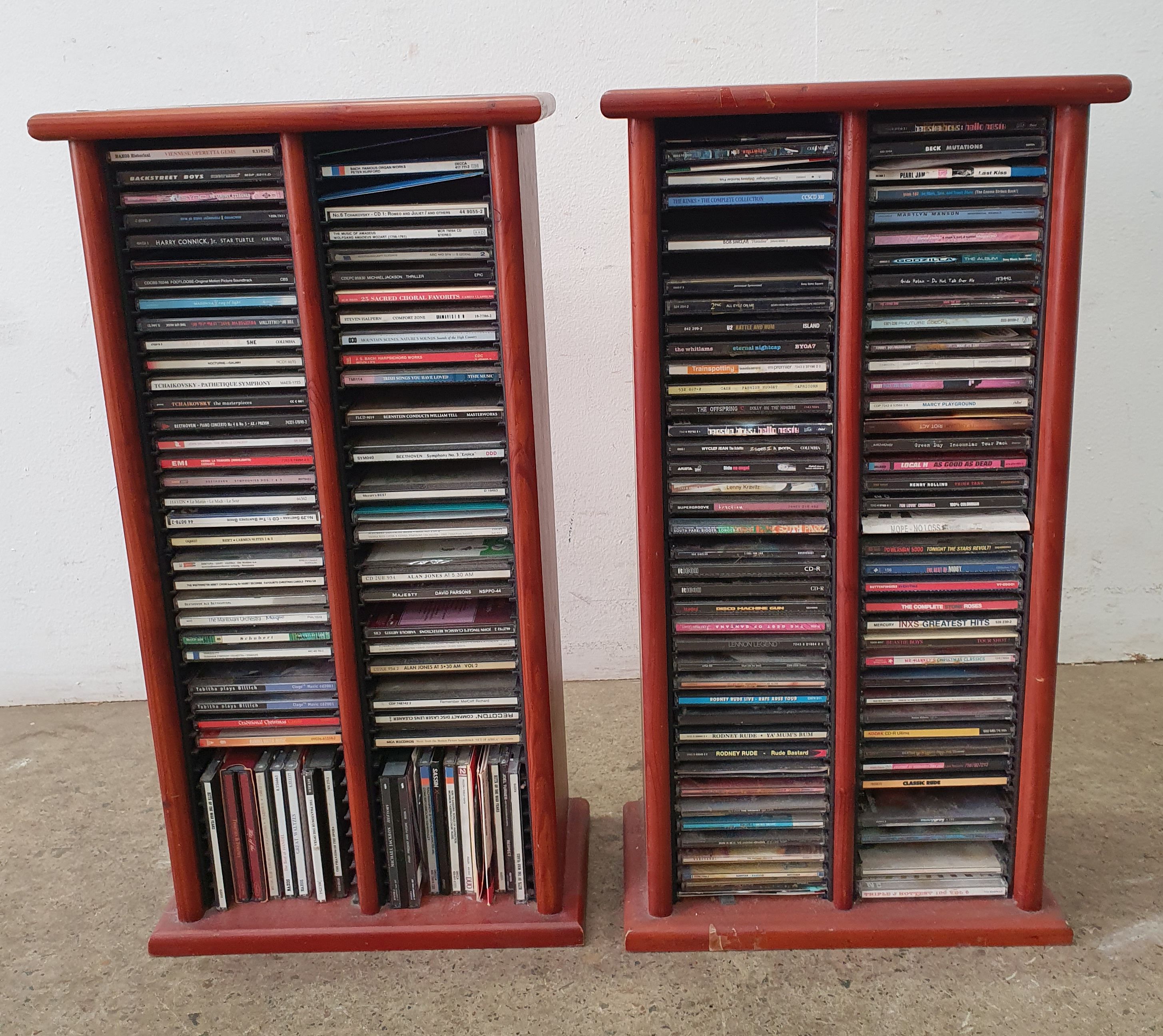 Two Various Groups Of Cd'S In Cd Racks