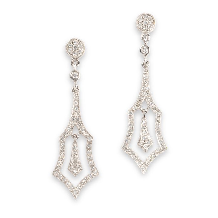 A pair of diamond and fourteen karat white gold pendant earrings