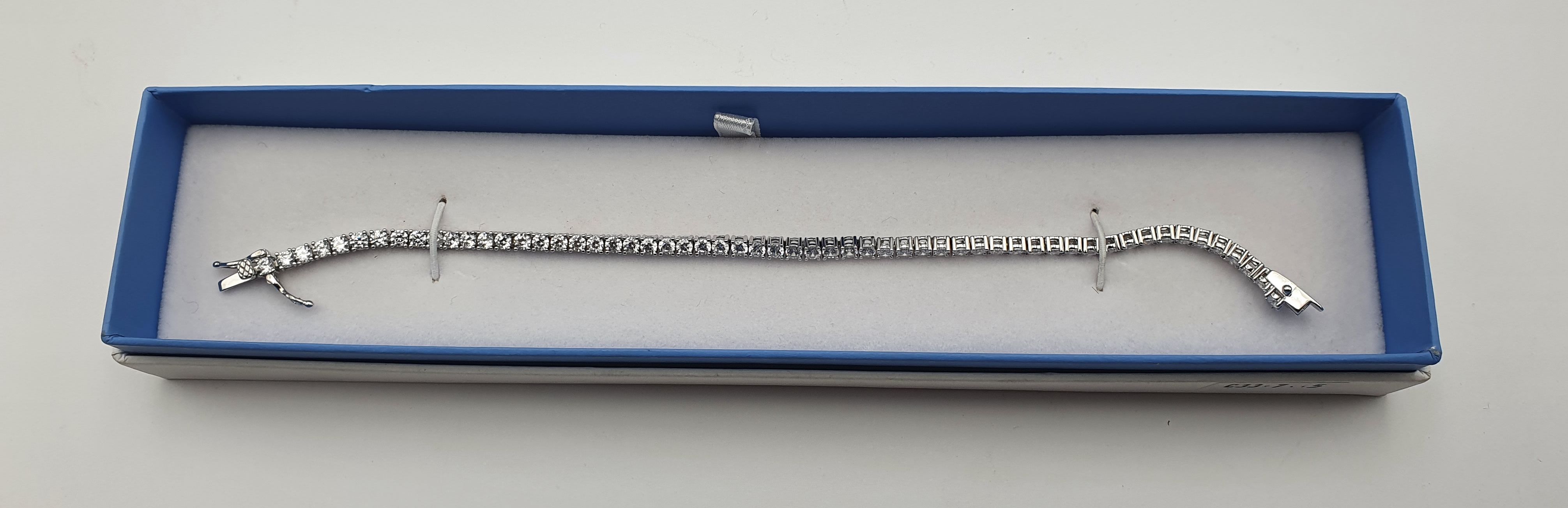 326 · A LADIES STERLING SILVE AND CZ-SET TENNIS BRACELET