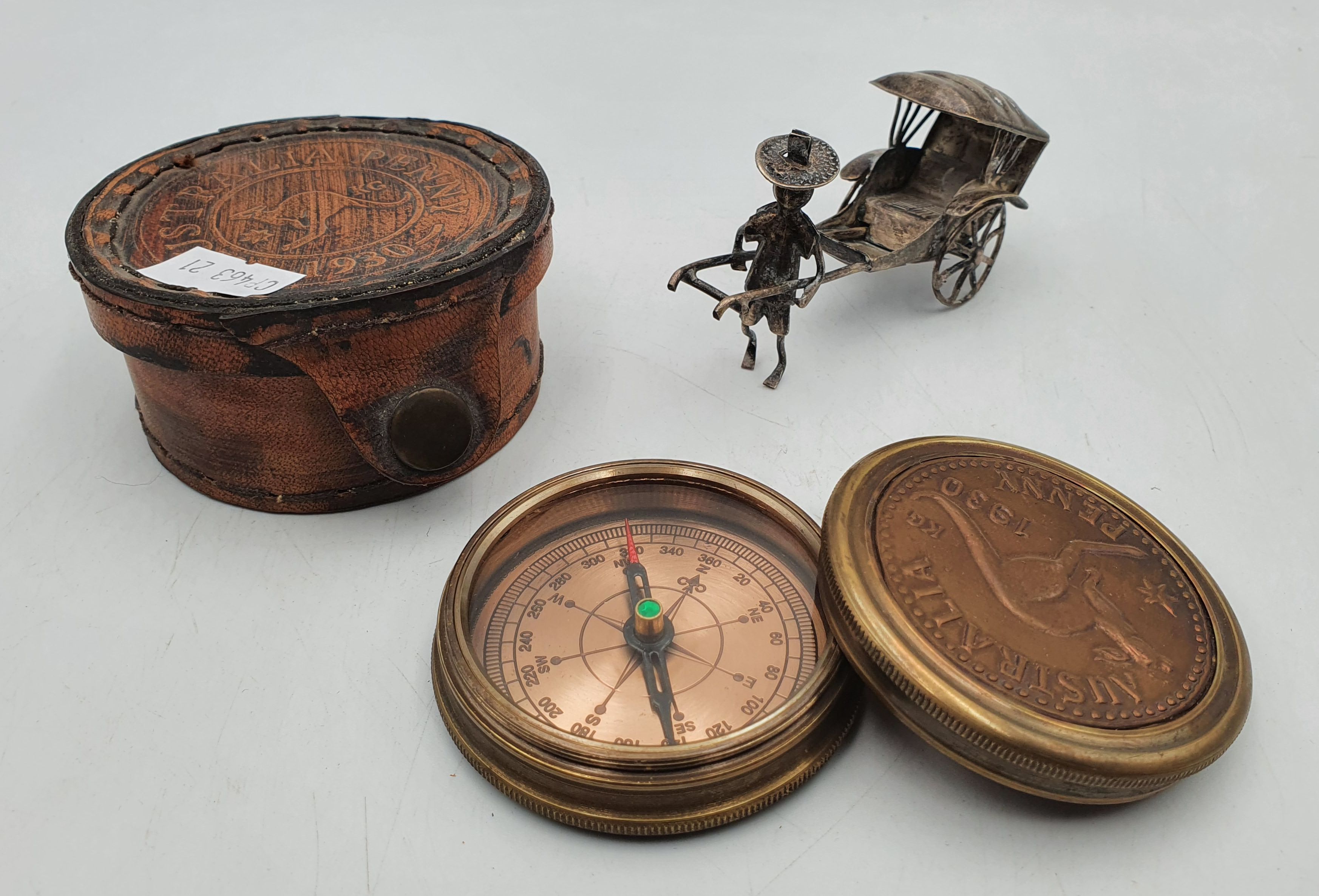 339 · A BRASS CASED COMPASS AND A WHITE METAL RICKSHAW