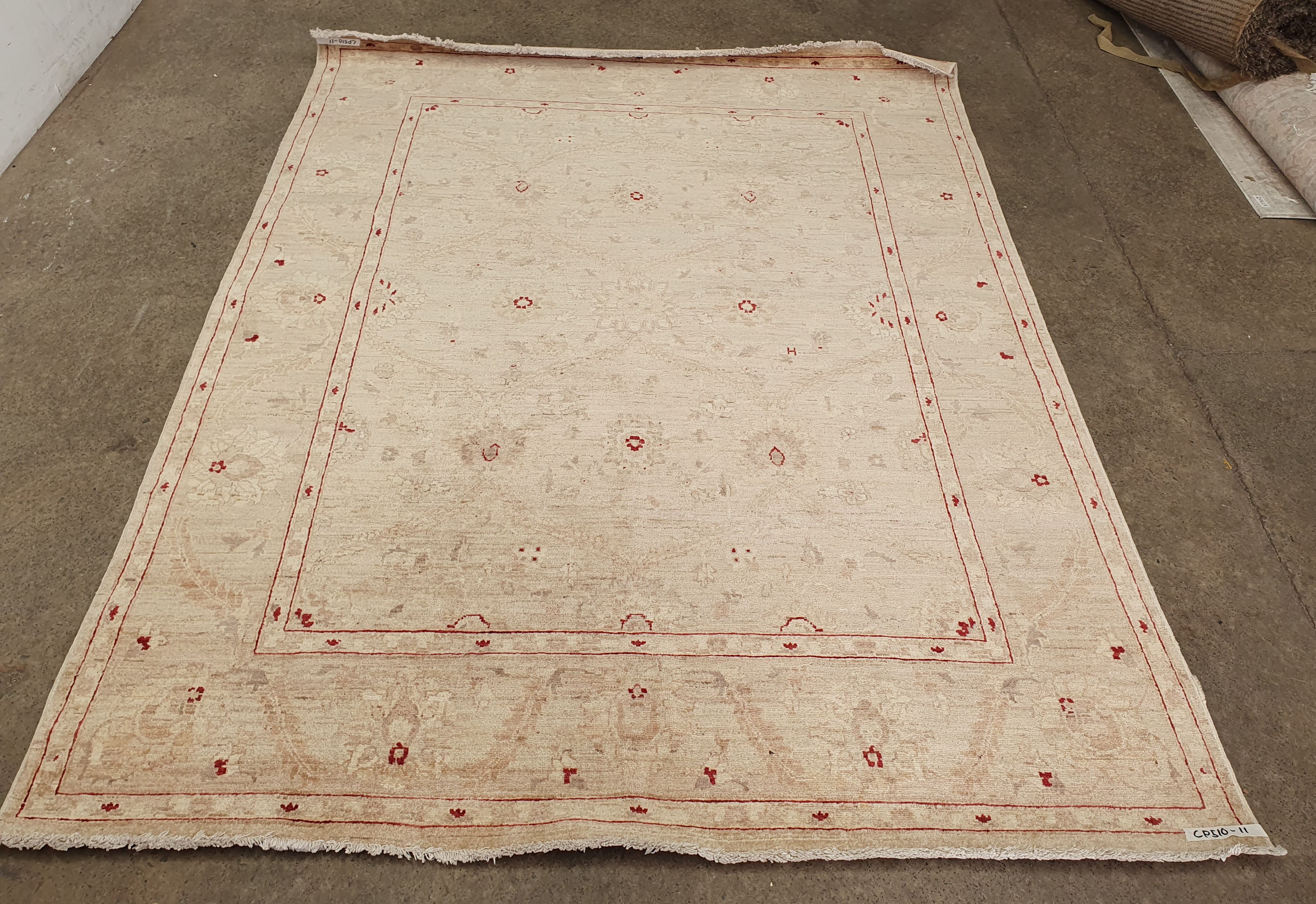 A HAND KNOTTED PURE WOOL RUG