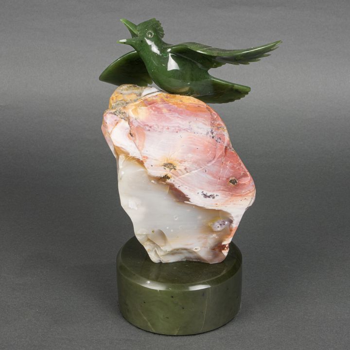 A Lyle Sopel carved jade figure of a bird alighting from a rock