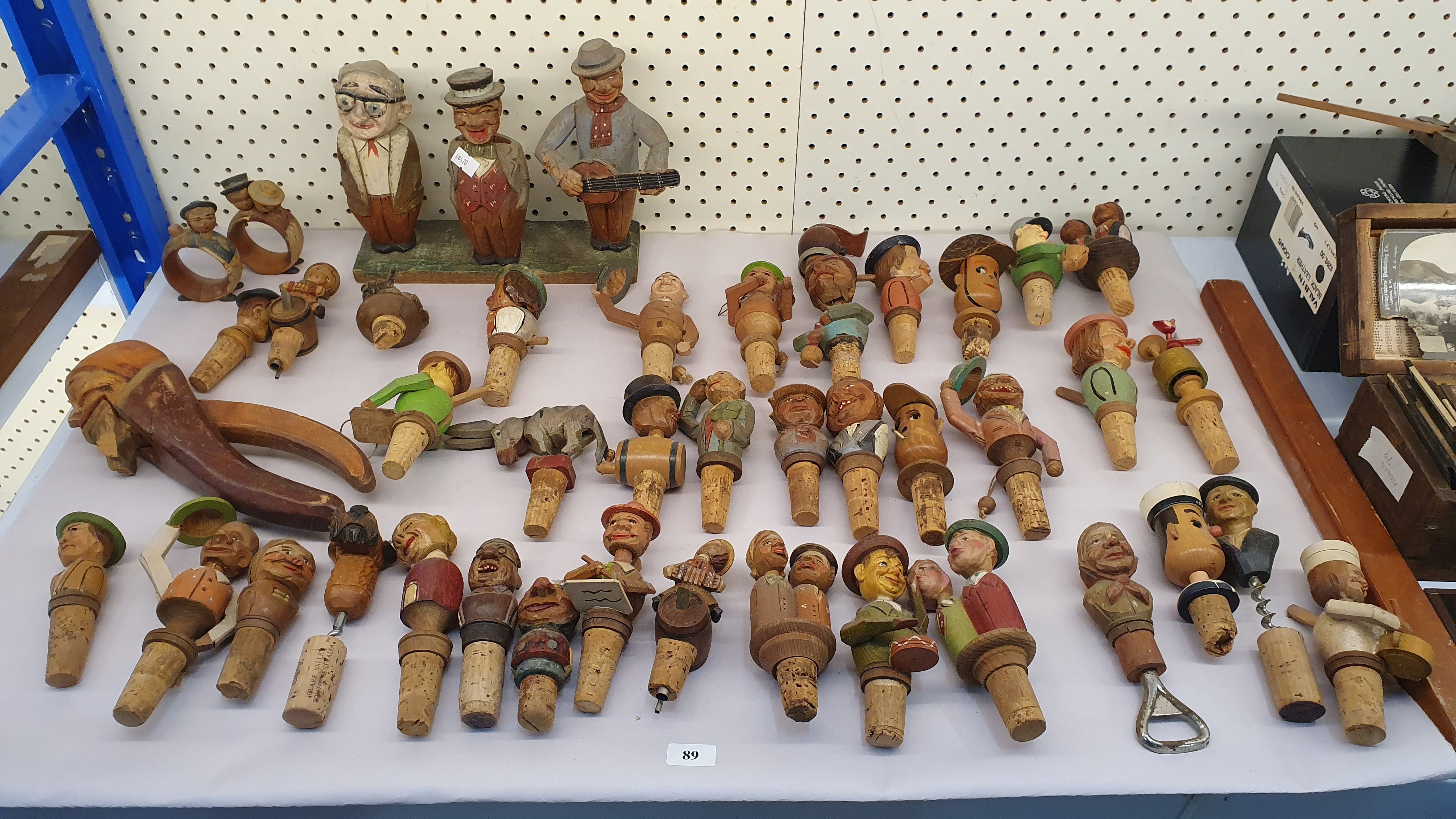 89 · A COLLECTION OF FIGURAL BOTTLE STOPPERS WITH CORK BASES