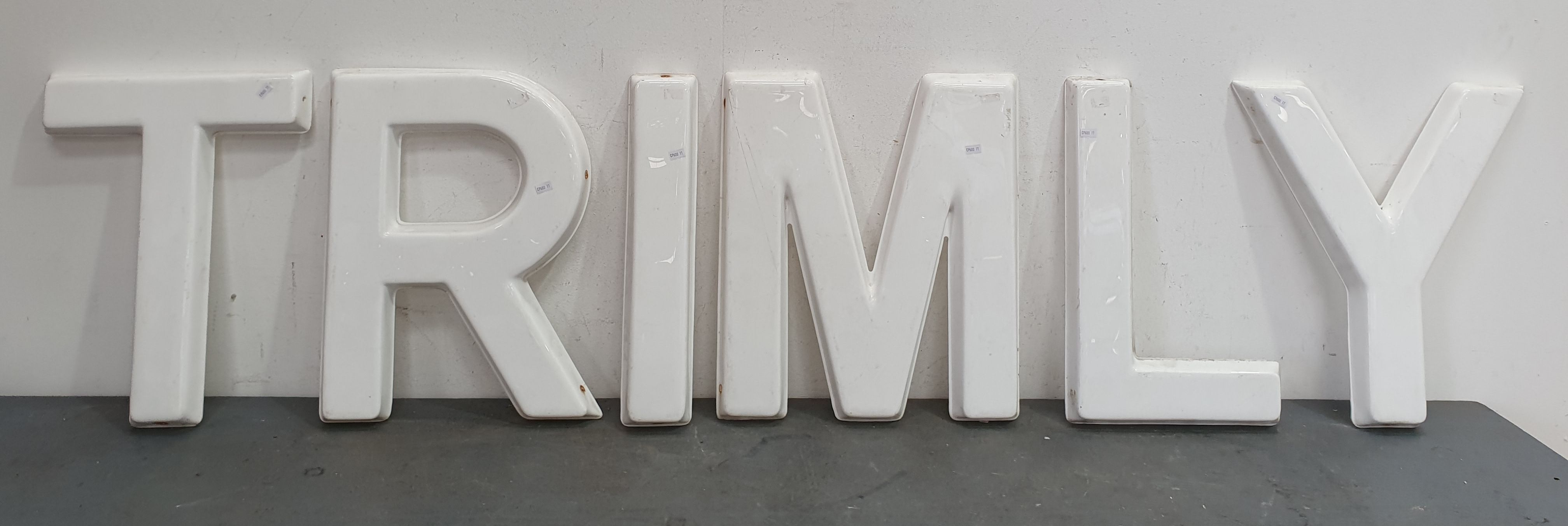 A GROUP OF PLASTIC LETTERS