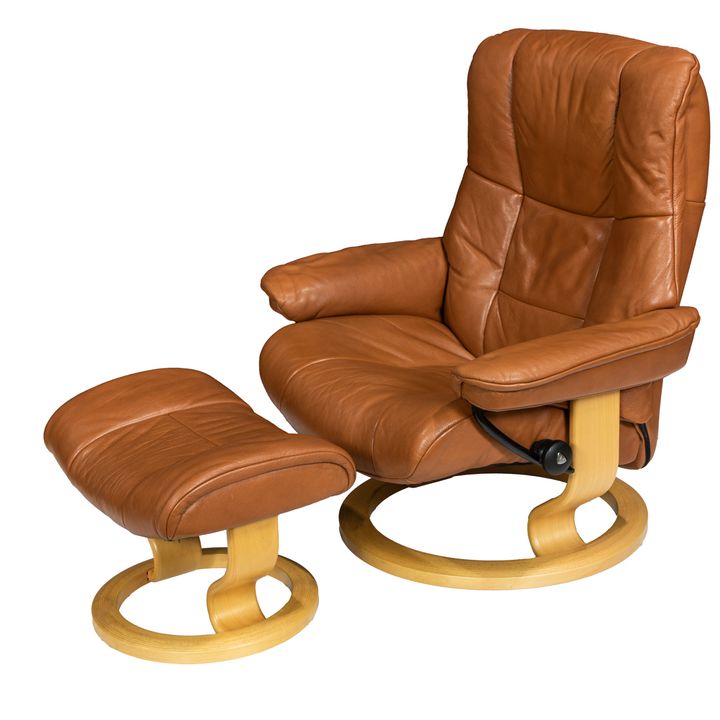 An Ekornes Stressless lounge chair and ottoman, executed in brown leather