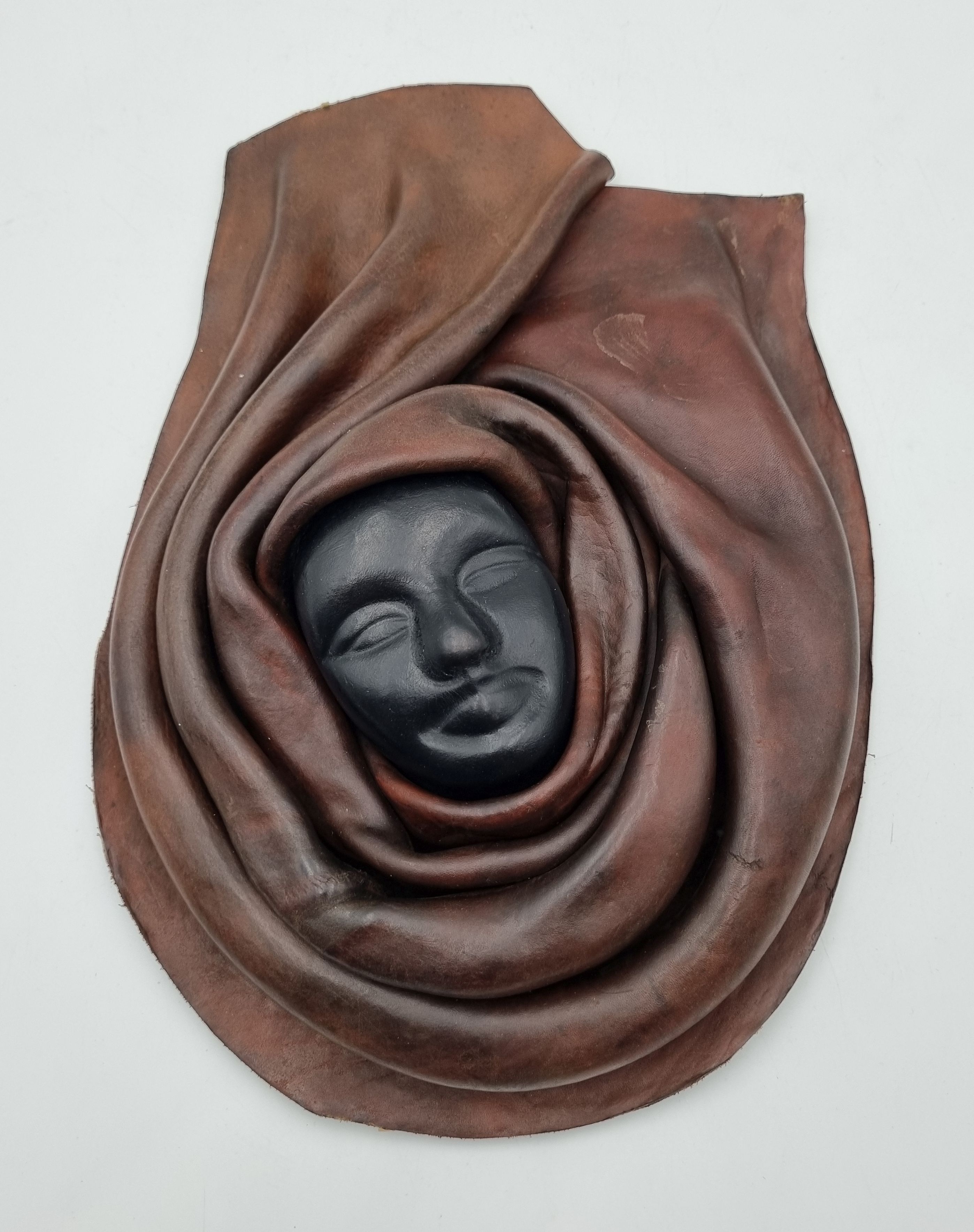 592 · A LARGE HAITIAN HAND SCULPTED LEATHER MASK