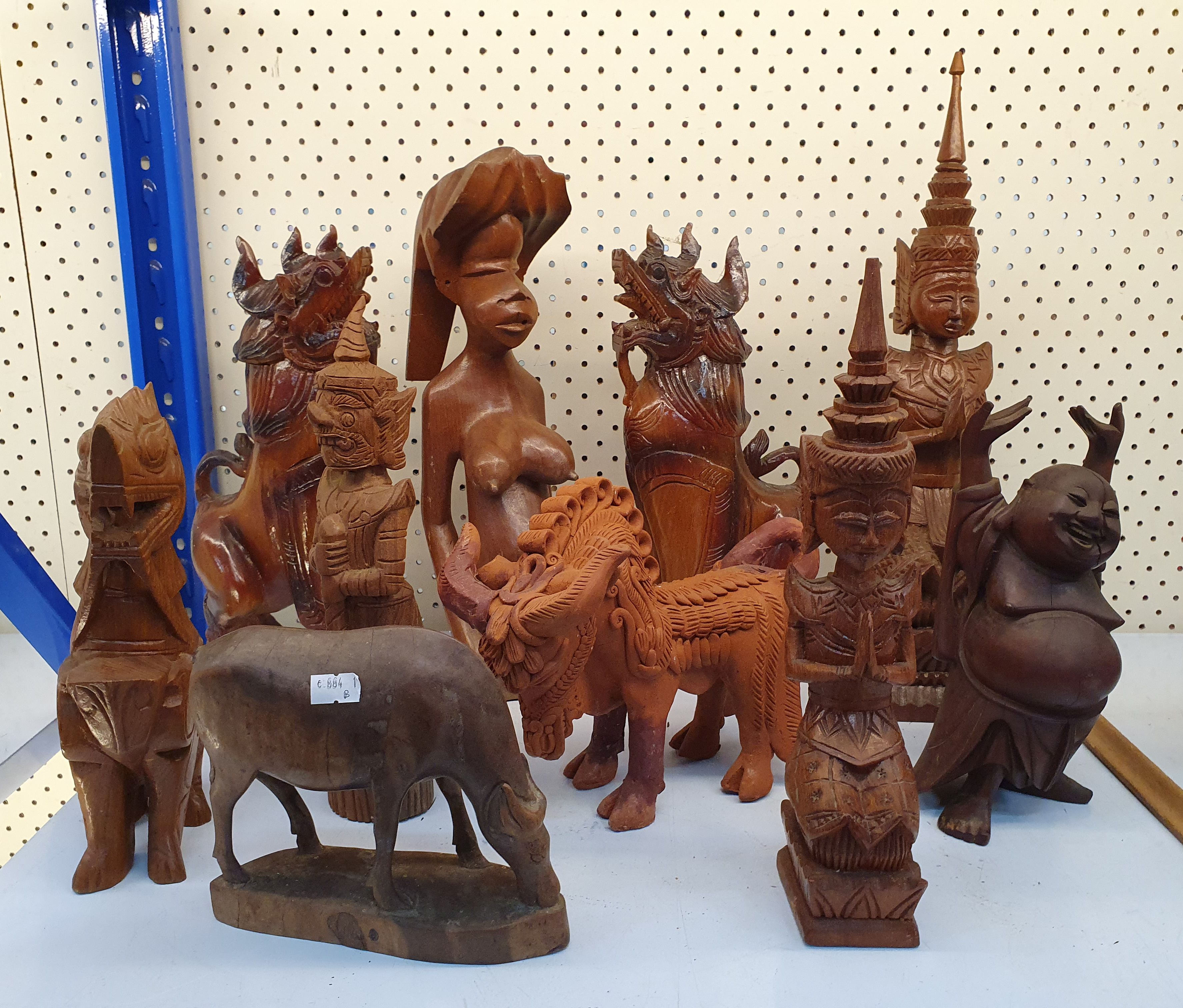 A Group Of Timber Carved Figures And A Terracotta Figure